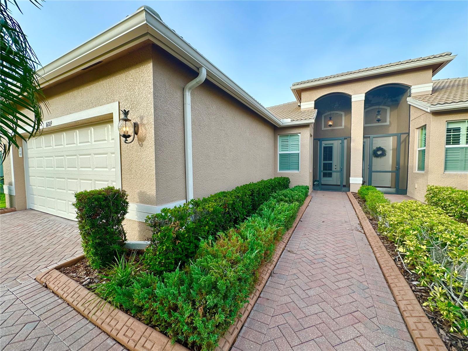 This gorgeous 2-bedroom, 2-bathroom Isabelle model in Valencia Lakes boasts a fabulous living space, perfect for Florida living. A large kitchen with a breakfast bar, granite countertops, stainless steel appliances, wood cabinets, and a picturesque informal dining area makes entertaining a treat.
The home spans 1524 sq. ft. and features ceramic tile throughout. The large open living and dining room is perfect for entertaining or relaxing. The sunroom offers breathtaking pond views, perfect for watching sunrises.
The large primary bedroom features an en-suite bathroom with a double vanity and walk-in shower and large walk-in closet. Additional highlights include a large 2-car garage and paver driveway and tiled roof.
Valencia Lakes is an amazing community with its array of recreational activities, social spaces, and convenient location, perfect for those looking for an active 55+ lifestyle. Enjoy a huge resort pool, a lap pool, and a resistance pool or just soak in the hot tub. Our state-of-the-art gym, exercise rooms, and fitness classes have something for everyone.
Other community amenities include basketball hoops, pickle ball courts, state-of-the-art tennis courts, bocce courts, and shuffleboard courts, as well as a beautiful softball field with concession stands. Don’t forget to visit the dog park and the gardens. The clubhouse features an amazing social hall for shows, dances, and dinners, as well as card rooms, art rooms pool tables and a soon-to-open café.
The community is situated in a perfect place for active 55+ living with easy access to the beach, downtown, Apollo Beach, and Riverview for dining and shopping needs, and easy access to I-75. Easy to show. Move in ready!!!