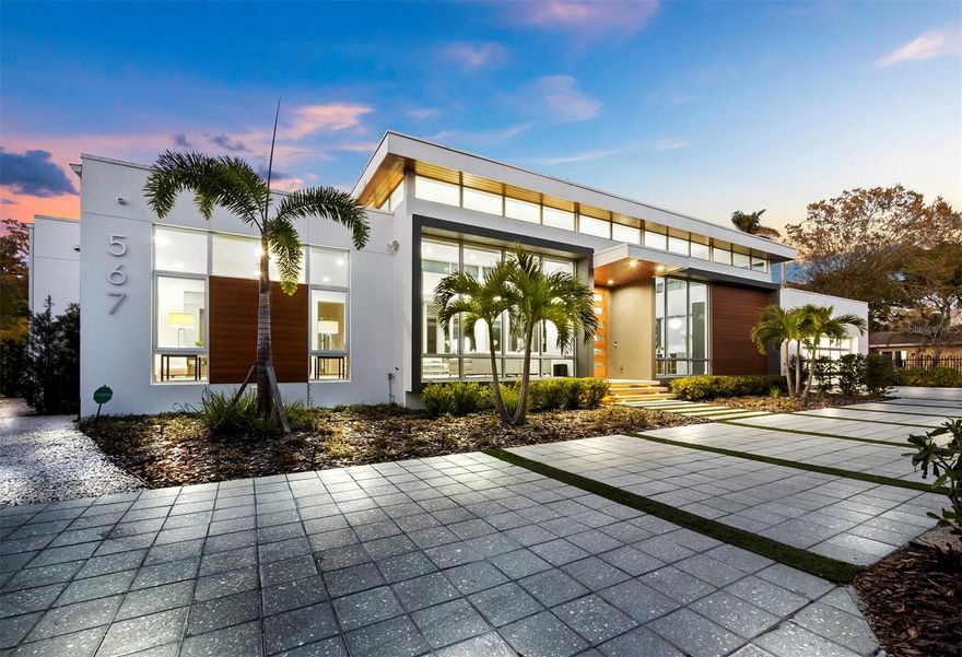 Absolutely stunning, this newer construction single-family home nestled in the Indian Beach Sapphire Shores district exudes refined elegance and contemporary allure. Boasting a coveted West of the Trail location, its proximity to Sarasota Bay and the vibrant cultural arts scene of downtown Sarasota adds to its allure. Tucked away at the end of a private drive in the Houses of Indian Beach enclave of homes, privacy and tropical surroundings abound. Exterior construction was completed in 2020, the current owners continued perfecting the interior finishes until complete in 2022. This better than new architectural marvel seamlessly integrates sustainable materials and smart technology with minimalist design principles. Crafted with meticulous attention to detail, it caters to those with a taste for masterful craftsmanship and modern sophistication. A grand entrance adorned with staggered gray stonework and wood accents sets the tone for the impeccable interior. Mahogany French doors with transom windows welcome you into a space defined by clean lines and a seamless connection to the outdoors. Easy living all on one level, this home features 3 bedrooms, 3 baths, and an open-concept design ideal for contemporary living. The gourmet kitchen, outfitted with European cabinetry, top of the line appliances, and quartz countertops, is a culinary haven. A spacious living and dining area provides the perfect setting for hosting gatherings or simply unwinding. One of the primary suites offers a serene retreat with direct access to an outdoor lanai and pool. An extra-large walk-in closets with custom cabinetry and a spa-like ensuite bath complete the luxurious experience. The additional primary suite is equally as luxurious and inviting. No expense was spared in the construction of this home, with features including hurricane-grade windows, energy-saving elements, and a full security system. Outside, a sleek saltwater pool with LED lighting and fountain display awaits, alongside a patio with a grilling station—a true oasis for year-round enjoyment. Impeccably designed and ready for occupancy, this modern masterpiece awaits its discerning new owner. Don't miss the opportunity to make this architectural gem your own.