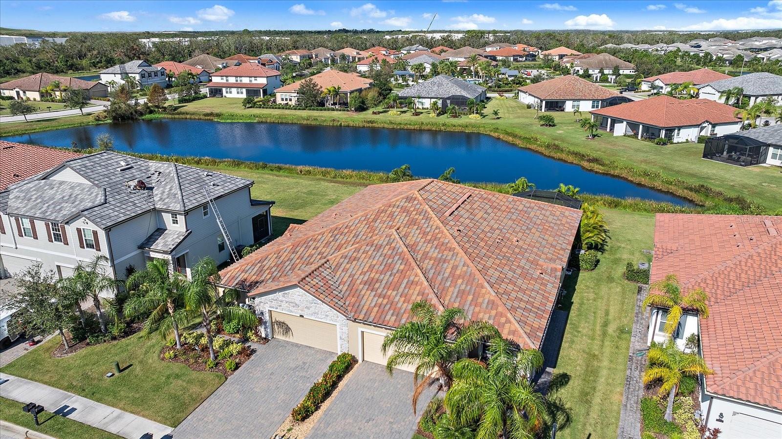 Live in Luxury in this spacious 2 Bedroom + Den single-story villa with more amenities than almost any other community in Lakewood Ranch!!! You only have to leave to get groceries or go to dinner! ***SPECIAL FEATURES INCLUDE: Water View, Custom Closets and Pantry, Crown Molding, Plantation Shutters, Multiple Accent Walls with wood trim or wallpaper, & Designer Light Fixtures. Kitchen is perfectly designed with Under-Cabinet Lighting, Designer pendants, Stainless Appliances, Gas Stove, Custom cabinets with pull-out drawers, Single Basin Undermount Sink, Shaker Cabinets, Backsplash, & Wood shelving in pantry. Custom draperies in primary bedroom w/matching shams & duvets to match. Custom draperies guest room. Motorized custom shades on slider doors. Den is equipped with Glass French Double Doors, Murphy bed, and Shelving. Primary Bath has Granite Countertops, Dual Sinks, and Frameless shower door in Walk-In Shower. Guest Bath has extra large Granite Countertop, Shaker Cabinets, Tub/Shower combo, and Wainscoting Hook wall. Additionally inside are Storage closets, Dimmers in living room, Wood Shelving added to laundry room, and Upgraded Ceiling Fans. Exterior Upgrades include: Shades on lanai, Glass Front door, Stone elevation, Landscape lights on front, Gutters, Water views, and Pavered Driveway.
*****RESORT COMMUNITY FEATURES****** Live on an endless vacation in this Resort-Style community filled with luxurious amenities with TWO Resort Style Pools and LOADS of resort amenities and close to EVERYTHING. Elegant Main Clubhouse is equipped with Zero-Entry Resort Pool with Lap Lanes, Full-Sized Fitness Center, Bocce Ball and Volleyball Courts with Full Time Activities Director (see below for more amenities). 2nd Pool area is EXCLUSIVE to the Villa/Townhouse residents. It is equipped with 2nd Resort-Style Pool, Hot Tub/Spa, Dog Park, and Pickle Ball Courts. Residents of this home have access to BOTH amenity centers!!! Just next door is Bob Gardner Community Park where you can find walking paths and soft trails, sports courts, a frisbee golf course, recreation pavilions, a gravity rail playground, and a small & large dog park. ***HOA COVERS***** Gates, 2 Zero-Entry Resort Community Pools with Lap Lane, Spa, and Sundeck overlooking the water, Full Sized Gym & Fitness Center, Community Manager, Onsite Lifestyles & Activities Director, Lawn & Garden Maintenance, Common Ground Maintenance, Irrigation, Pickleball, Bocce Ball, Volleyball, Dog Park. ***LOCATION: Centrally located. Just outside the gates are A+ schools, Gullett Elementary, Lakewood Ranch High School, and Mona Jain Middle School, LECOM, & Manatee Tech East Campus. Minutes to shopping, restaurants, gyms, salons, bars, etc. Minutes to downtown, Sarasota International Airport, the top rated beaches in the country, UTC Shopping.