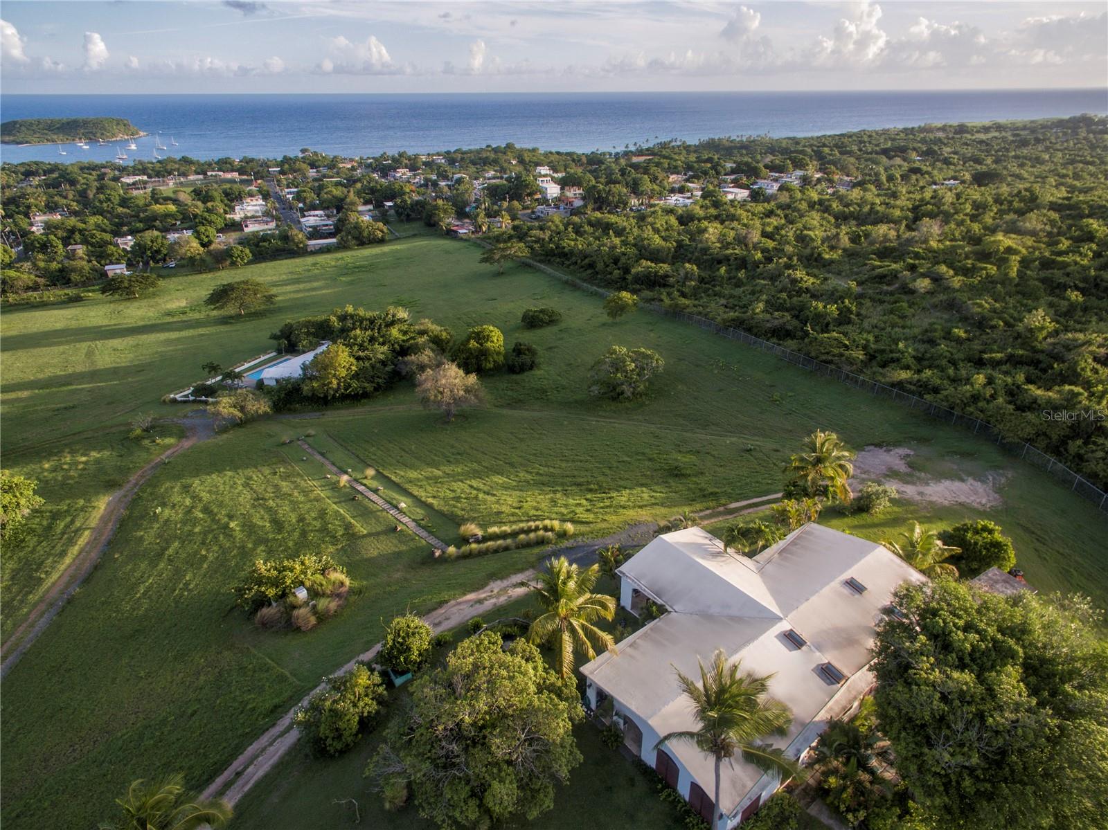 Once in a lifetime, El Cerro - The Ultimate Caribbean Retreat perched on a hilltop with Expansive Caribbean Views is now being offered for sale. This unique hilltop property consists of thirty acres and includes three different homes. Each allows solitude from the others yet they are connected by the privacy experienced within the confines of the fenced estate. The property comprises eight bedrooms and nine bathrooms and includes a beautiful swimming pool and sauna. The convenient access is from the nearby Esperanza Village and is entered via electronic access control and boasts a haven of privacy and unparalleled views of the Caribbean.
The Main House has four luxurious bedrooms all with en suite bathrooms. This home also offers spacious living, dining and kitchen areas and extraordinary Caribbean views. The Rock House has three bedrooms and three bathrooms, living, dining and kitchen areas all with birds eye Caribbean views. The Pool House has one bedroom and full bathroom. It also has kitchen, living and dining areas and a sauna all situated adjacent to the gorgeous swimming pool which has an additional exterior bathroom.
The property has a manager/caretaker home that is attached to the garages used for the storage of equipment and vehicles. This magnificent and one of a kind Vieques estate borders thousands of acres of grazing land owned by the Municipality of Vieques adding unprecedented privacy surrounded by nature.