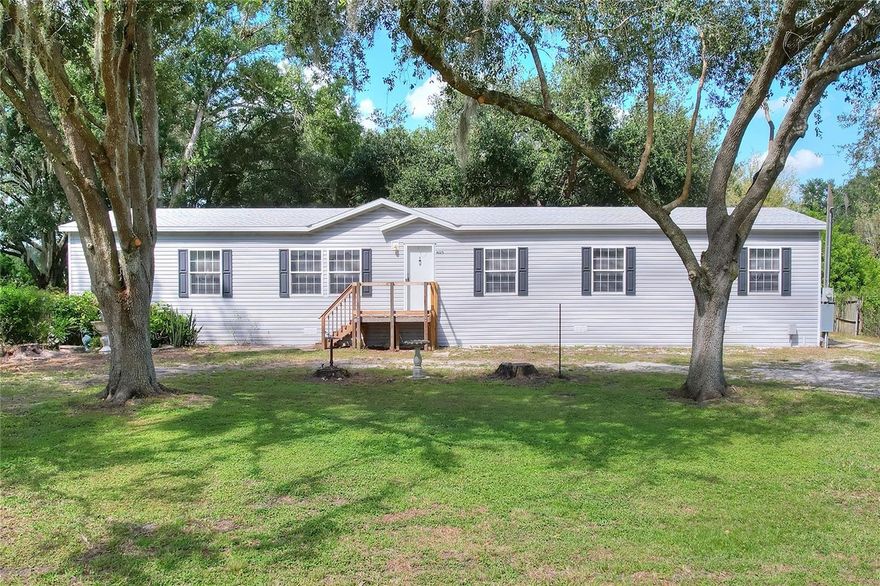 Welcome home to this spacious and beautifully updated 5-bedroom, 3-bath manufactured home situated on a peaceful, fully fenced ½-acre lot in lovely Auburndale, Florida! Inside, you’ll find lovely interior with a new roof, fresh paint, and new carpet throughout. The large front living room greets you upon entry and flows seamlessly into the back den/dining area and kitchen, offering two generous living spaces for relaxing or entertaining. The kitchen features beautiful cabinetry, a large island, ample counter space, and contrasting appliances, with the laundry room conveniently located just off the kitchen—washer and dryer included.

The oversized primary suite offers a private retreat with an ensuite bathroom featuring a large soaking tub, double sinks, and a walk-in shower. Bedroom 2 includes its own private bath, ideal for guests or extended family, while the additional bedrooms are generously sized with a well-appointed guest bath.

Outside, enjoy two covered areas, including a very large covered carport in the back—perfect for parking, storage, or outdoor projects. With no HOA, there’s plenty of space for your boat, RV, or pets, giving you the freedom and flexibility you’ve been looking for. All of this is just minutes from shopping, dining, and major roadways, yet still offering that peaceful country feel.

This one won’t last long—schedule your private showing today!