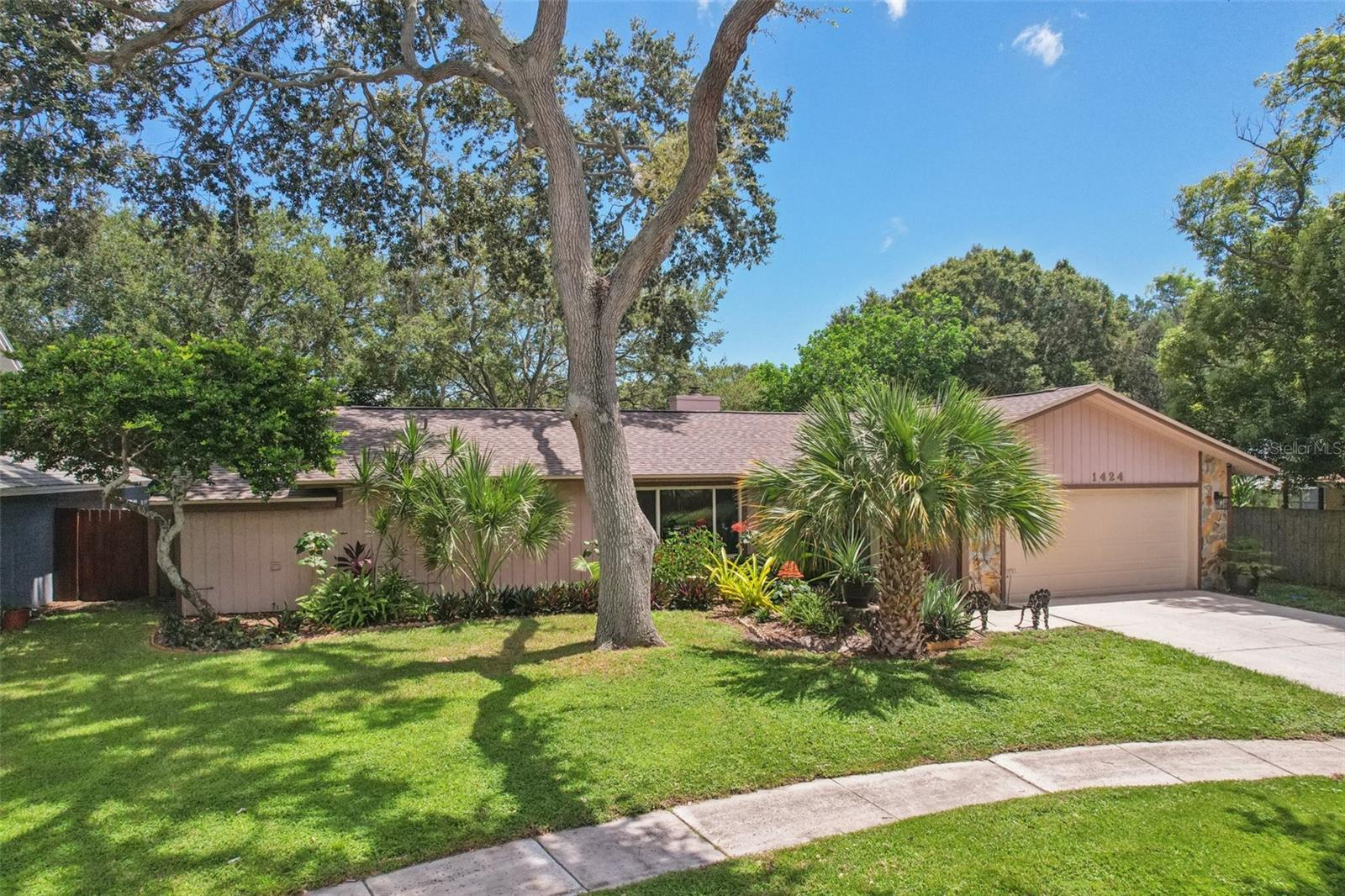 Welcome to your Home Sweet End-of-Cul-de-Sac POOL home! Located in the quaint Rosetree Court community centrally located in Clearwater near major junctions. This one story, Split Floorplan, 3 bed, 2 bath, 2 car-garage home sits at the quiet end of the cul-de-sac. Newer ROOF only 3 years old as well as Hurricane Impact Windows and and Garage Door to save you money on insurance! Enter in through the glass storm door to find a wonderful floorplan that truly flows. First a formal living or dining room in the front with an oversized picture window. Then on to the heart of the home, a fabulously remodeled kitchen featuring high-end solid wood cabinetry with all the bells and whistles including: a wall of cabinets that showcases the coveted kitchen ‘garage’ to store your bakery goods; as well as a dedicated beverage section with apothecary drawers, wine and glass rack, an expansive pantry with pull out drawers, a pull-out kitchen table. All of this graced by sophisticated granite countertops that encompass the breakfast bar and middle island. For ease of entertaining and everyday living, the kitchen is open to the spacious family room which features a warm and cozy wood-burning stone fireplace and sliders to the pool area. This is a true split floorplan with the two guest bedrooms and full bath being next to the family room. A couple of fun features are a computer room off of the kitchen and a Mickey Mouse shaped sink in the guest bath! Then for maximum privacy the primary bedroom is on the other side of the home and boasts a walk-in closet, slider out to the pool and a generous ensuite bathroom with dual vanities as well as the laundry room for convenience. The backyard will provide hours of relaxation and entertaining with its large pool and screened Lanai to be able to enjoy it in all seasons! HVAC is 8 years old, Water Heater is 4 years old. Just around the corner from the highly rated Discovery Academy of Science (K–8) and just a short drive to Clearwater Beach, St. Pete–Clearwater Airport and Tampa International.
