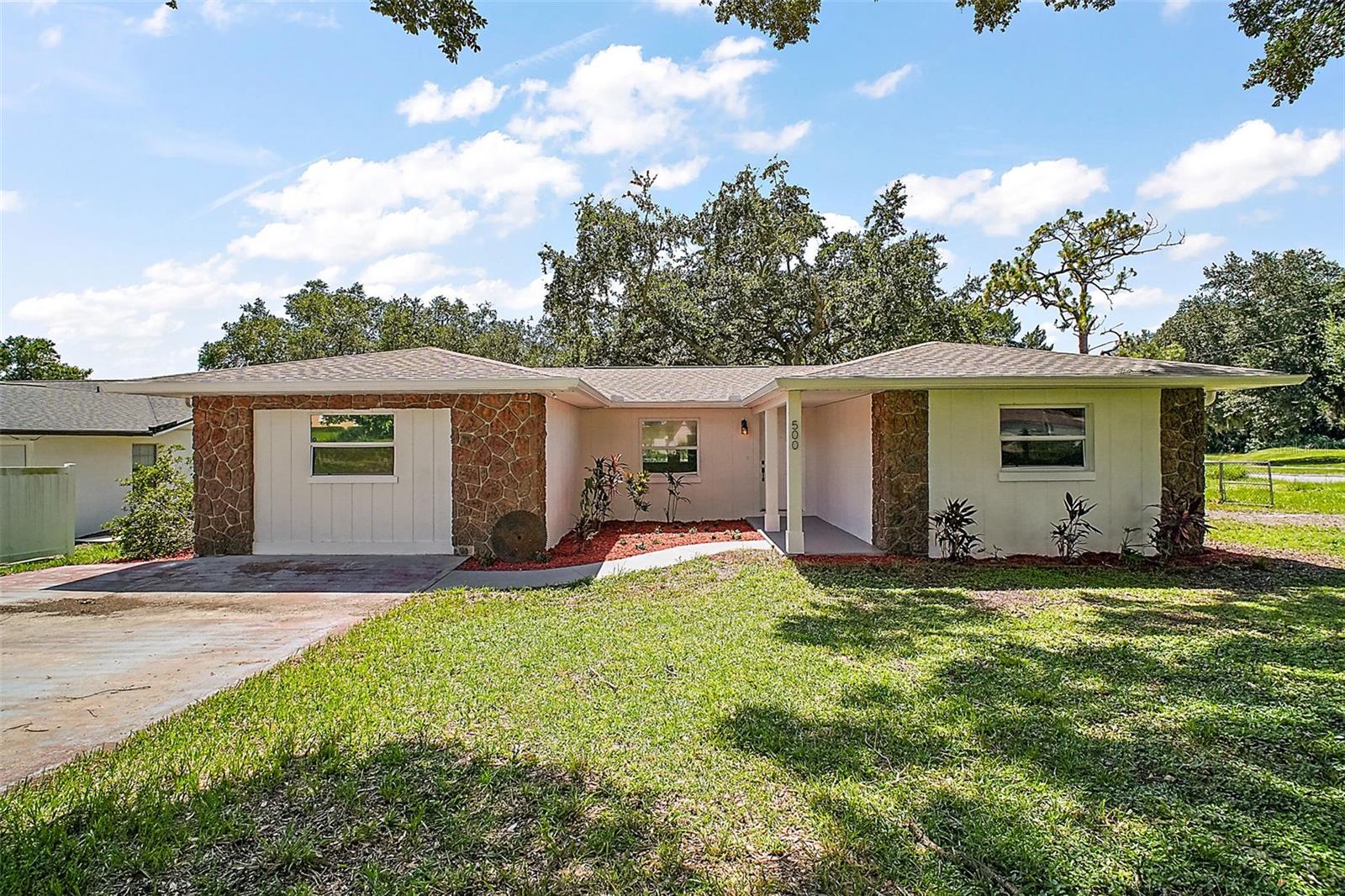 500 Shady Nook Drive is a move-in ready lakefront home on private Shady Lake, close to downtown Clermont, walking distance to Aurelia Cole Elementary School, the public boat ramp and lakefront walking trails. NO HOA, oversized corner lot, fenced with mature "shady" oak trees, boat parking and a storage shed. The home has been freshly painted inside and out, you're invited in to a large open floor plan with a designated dining space, a living room that opens to the kitchen and a bright and airy Florida Room overlooking the yard and lake. On the north side of the house you have two guest rooms and the primary en-suite featuring fresh flooring and two bathrooms. Through the kitchen is a hallway that accesses the utility room, bonus room and oversized laundry room with exterior access. The bonus room has the potential to be converted to an in-laws apartment, space for an additional bathroom, a home office or simply 4th bedroom. New roof installed 2023, HVAC 2017, re-piped 2024, water heater 2023. A blank canvas with all the major updates completed, you will love the location and charm of this home and community.