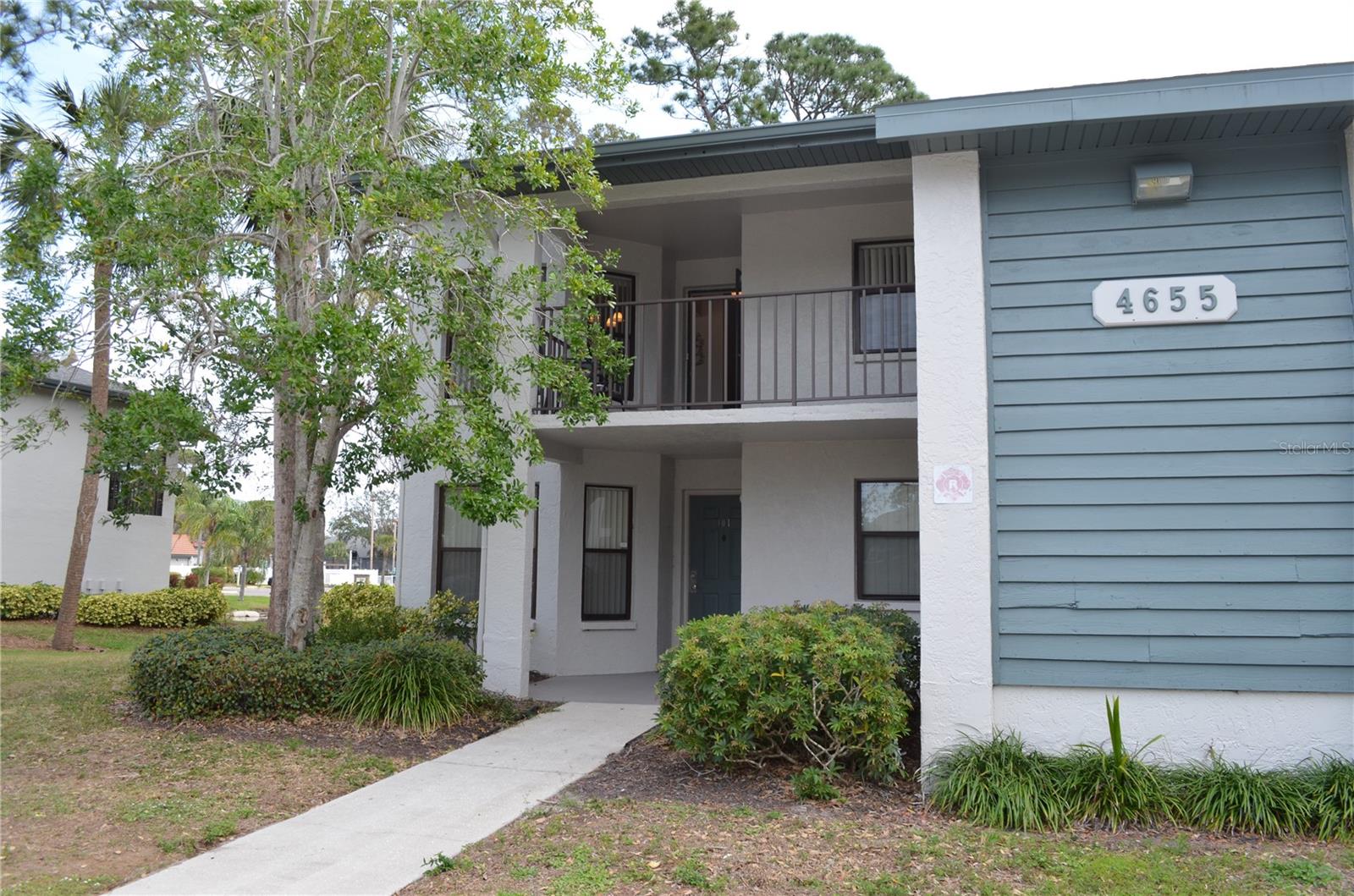 Beautiful second floor corner condo, 2 BEDROOMS AND 2 FULL BATHS , the Guest Suite has a tub, and the Primary bedroom has a shower. Owned by seller since 1990 and Used as a second home, never rented, so owner says: it LOOKS like new. It is located near and in view of the clubhouse and pool, just a short walk away. Sellers spent $14,000 on the kitchen upgrades in recent years, the rich wood tone of the kitchen cabinets are matched with the new finish on the pantry door as well as on the one of a kind HIGH Table and chairs in the kitchen nook where you have a great view .. You can relax on the screened back porch which overlooks the nearby pool & Clubhouse area. There is an Electric BBQ for your cooking needs and there is also a BBQ area at the Clubhouse.
The living room features an Electric fireplace, it can provide blown heat or just a flaming light show . HIGH CEILING FROM 12 FEET SLOPES DOWN TO 8 FEET. Comfortable furnishings will remain with the unit at the sale. The bedrooms have laminate floors and ceramic tile is in the kitchen, porch, baths and the living areas. The owners just re-painted most areas.