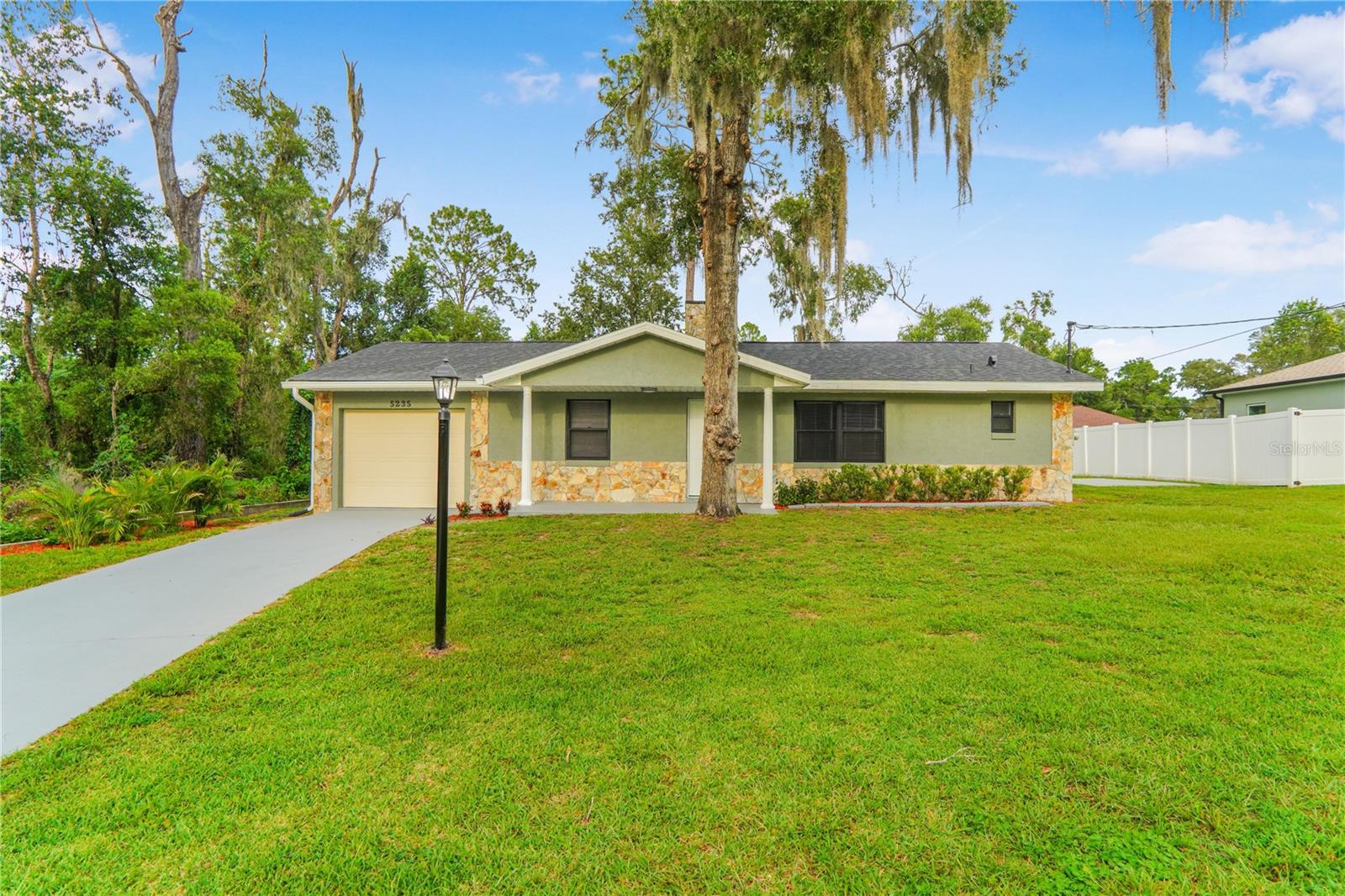 Welcome to your beautifully updated single-family home, nestled on an expansive 0.44-acre lot in the heart of Inverness, Florida. This 2-bedroom, 2-bathroom gem has been fully renovated and is move-in ready! Step inside to discover brand-new laminate flooring throughout, fresh interior paint, and new doors that enhance the modern feel. The open-concept kitchen features quartz countertops, new stainless steel appliances, and ample cabinet space — perfect for both everyday living and entertaining. The living room features a fireplace that was converted from wood to electric with stones beautifully added all around it. Enjoy peace of mind with a new roof, new washer, dryer, and an AC unit replaced in 2019. The large covered and enclosed back patio is ideal for relaxing or hosting gatherings year-round, overlooking the spacious backyard, which includes a storage shed and fence giving you even more privacy. Other upgrades include a gas tank available outside for a pool heater or gas stove, new recently added garage door and gutters. Situated on nearly half an acre, there’s room for gardening, outdoor activities, or even adding a pool. Whether you're a first-time homebuyer, downsizing, or looking for a Florida retreat, this home offers comfort, style, and space in a serene neighborhood. Schedule your showing today — this turn-key beauty won’t last long!