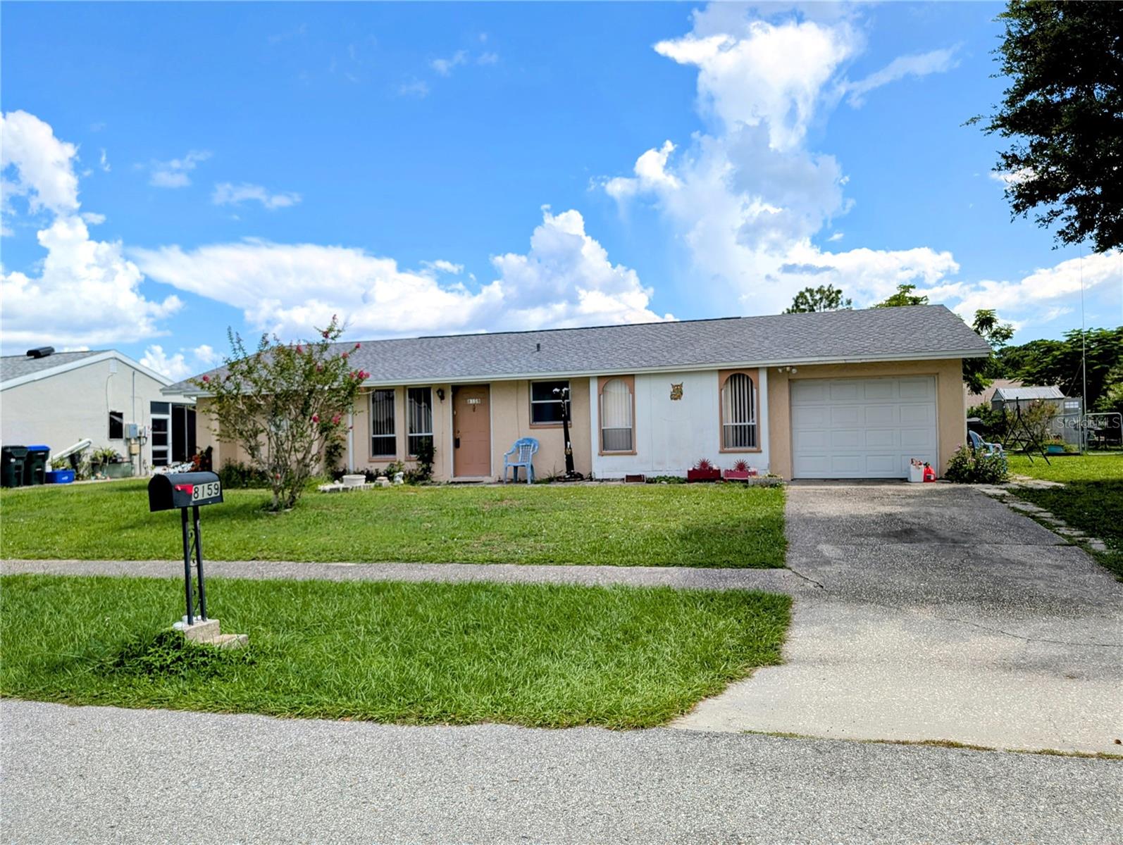 Step inside this cozy 2-bedroom, 2-bath home in the heart of North Port, Florida, and you’ll see why it’s such a rare find. With city water and city sewer already in place, this home offers convenience, comfort, and plenty of space to enjoy. One of the first things you’ll notice is the newer roof, installed in 2023, giving you peace of mind for years to come. The living areas feature easy-care tile flooring, while the bedrooms are designed for comfort with soft carpet underfoot. Both bathrooms are finished with practical linoleum flooring. The master bedroom is truly impressive—generously sized with a closet so large it almost feels like its own room. The master bathroom includes a spacious walk-in shower and a long countertop that makes getting ready simple. The second bedroom is also oversized, and its closet stretches the length of the room, giving you more storage than you’ll know what to do with. The kitchen is light, bright, and inviting, with plenty of space to prepare your favorite meals. Step outside to the screened lanai, complete with outdoor carpet, a ceiling fan, and shades designed to block the hot Florida sun while you relax or entertain. The backyard is filled with tropical flowers and greenery, creating a beautiful backdrop and plenty of room to design the outdoor space of your dreams. Whether you want to garden, entertain, or simply enjoy the fresh air, this yard offers endless potential. The one-car garage is more than just a place to park—it has space for your washer, dryer, tools, and extra storage, keeping everything organized and accessible. This home combines comfort, space, and convenience in a fantastic North Port location. Don’t miss the chance to make it yours!