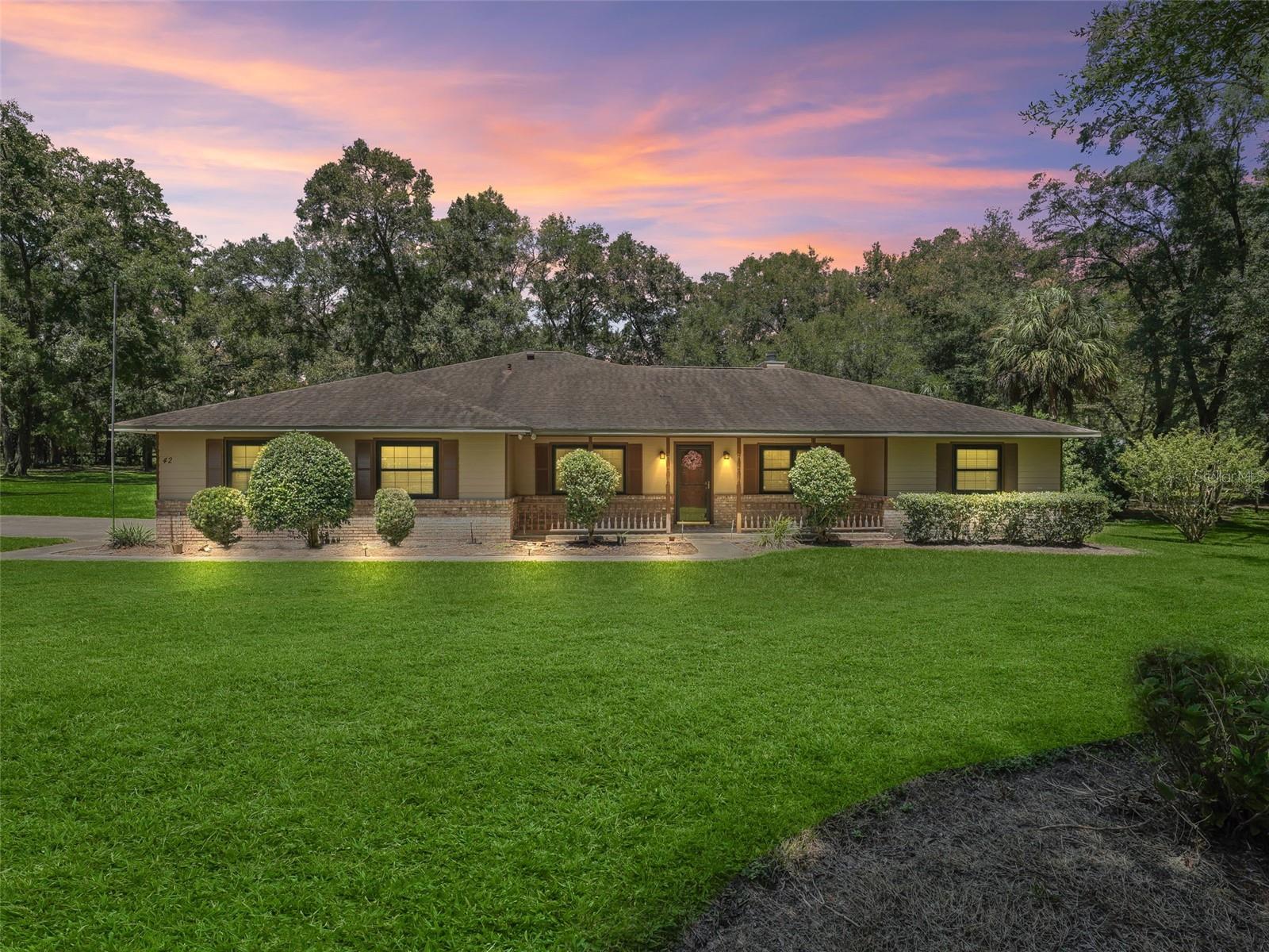 Welcome to this Pool Home situated on 2 acres in Meadow Wood Farms! This fully-fenced corner lot offers a park like setting with mature trees and landscaping plus a 36' x 40' pole barn with 14' tall center aisle to store your RV/toys, or easily convert to a horse barn. The 3 Bedroom, 2 Bathroom plus Office Home offers a side entry 2 car garage, brick accents with hardie board siding and a covered front porch for your rocking chairs. Inside, the foyer features laminate flooring that leads into the open floor plan and carries throughout the home with tile in the wet areas. The living space offers vaulted ceilings, and a wood burning fireplace with painted brick facade. The kitchen features stainless steel appliances including gas range and French door fridge, an adjacent formal dining space and breakfast nook. The split bedroom layout offers a spacious primary suite with access to the Florida room, ensuite bathroom with dual sink vanity, walk-in shower, garden tub and walk-in closet. On the opposite side of the home are two additional bedrooms that share a full bathroom with a tiled shower/tub combo with glass door. Additionally, there is a dedicated office with French doors in the front of the home. The enclosed Florida room leads to the screen enclosed pool overlooking the private backyard. Beyond is a grilling area, large storage shed and the pole barn with room for RV parking and more. Additional updates and features include: new roof in 2014, new double pane windows in 2018 and 2021, new well pump and tank 2020, new pool pump 2021, exterior paint 2021, 30 amp outlet in garage and more. Meadow Wood Farms is a beautiful community with miles of paved roads and tree lined streets that welcomes horses and barns - located in NW Ocala just 15 minutes to The World Equestrian Center! Please enjoy the attached 3D tour!