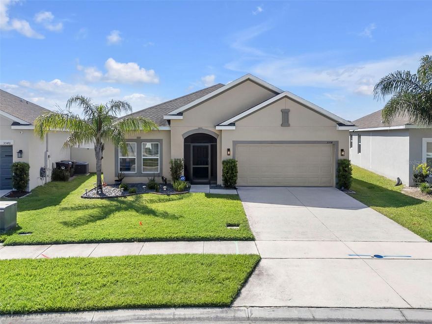 MOVE-IN READY 4-bedroom, 2-bath home built in 2019, featuring UPDATED FLOORING and a FENCED YARD in the established Whaley’s Creek community of St. Cloud. This Central Florida real estate property presents a clean, functional layout with modern finishes, ideal for buyers seeking a St. Cloud home with convenient access to major roadways and surrounding areas.

As you arrive, the home presents a well-maintained exterior with a manicured lawn, palm tree landscaping, a spacious driveway, an attached 2-car garage, and a screened front entry. Inside, wood-look tile flooring extends through the main living areas, where natural light enters through multiple windows and creates a comfortable, open atmosphere.

The main living area connects directly to the dining space and kitchen, creating a practical layout for everyday living and gatherings. The kitchen is centrally located and includes quartz countertops, 42-inch cabinetry, stainless steel appliances, a tile backsplash, and a center island for additional workspace. The adjacent dining area overlooks the backyard through sliding glass doors.

The primary bedroom is positioned toward the rear of the home and includes a walk-in closet and an en-suite bathroom with dual sinks, quartz countertops, and a glass-enclosed walk-in shower with tile finishes. The additional bedrooms are well-sized with carpet flooring and provide flexibility for guests, office space, or other uses. One room is currently set up as a media or workspace. The secondary bathroom includes a tub/shower combination and quartz countertops.

A covered SCREENED LANAI extends the living space outdoors, providing a shaded area for seating while overlooking the fully enclosed vinyl-fenced backyard. Additional features include recessed lighting, a dedicated laundry area, and functional storage throughout.

Whaley’s Creek includes community amenities such as a pool, playground, park, and sidewalks. The property is located near shopping, dining, grocery options, and access to the Florida Turnpike for travel throughout St. Cloud, Kissimmee, Orlando, and the greater Central Florida area.

Contact us today for a private tour or more details on this exceptional opportunity.