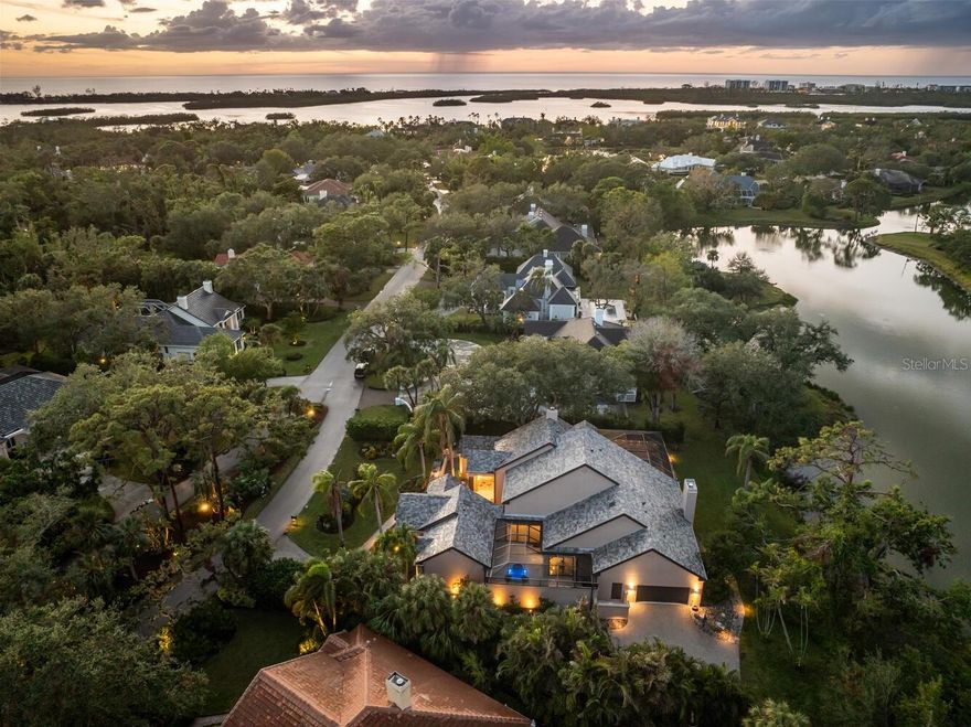 Nestled in the prestigious gated enclave of The Oaks Bayside in Sarasota, this Sedona-inspired retreat was recently updated from wall to wall creating a like brand new home. The estate seamlessly blends modern luxury, comfort, and serenity. With almost 4,000 SQF and boasting 4 generously sized bedrooms and 3 1/2 baths, this residence has been thoughtfully renovated with the finest finishes, including newer impact windows, retractable window walls, a sleek tile roof, custom concrete flooring, and exquisite baths and fixtures to go along with the state-of-the-art kitchen, equipped with top-tier Wolf and Sub-Zero appliances. Soaring vaulted ceilings create an expansive, airy ambiance, while large windows frame stunning lake views, offering the perfect backdrop for the sparkling pool and expansive spa, complete with tranquil water features. With disappearing sliders throughout, the home can let the air and light flow easily from outside to in. Enjoy breathtaking sunsets from your private oasis or stroll a kayak or paddleboard to the nearby boat launch for effortless access to Sarasota Bay and the Gulf, thanks to the newly reopened Midnight Pass. Situated on a secluded .40-acre lot, this property offers a serene retreat, featuring a Zen garden surrounded by lush landscaping. Residents of The Oaks enjoy world-class amenities, including championship golf, fine dining, tennis, fitness, and swimming. At 49 Osprey Point Drive, every detail has been meticulously crafted for those who seek refined living and unparalleled elegance.
