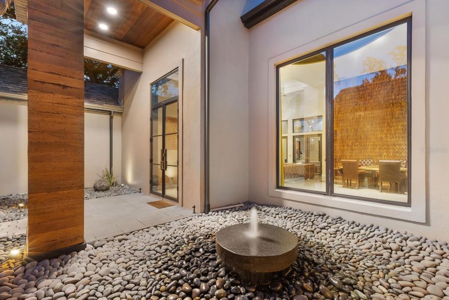 Nestled in the prestigious gated enclave of The Oaks Bayside in Sarasota, this Sedona-inspired retreat was recently updated from wall to wall creating a like brand new home. The estate seamlessly blends modern luxury, comfort, and serenity. With almost 4,000 SQF and boasting 4 generously sized bedrooms and 3 1/2 baths, this residence has been thoughtfully renovated with the finest finishes, including newer impact windows, retractable window walls, a sleek tile roof, custom concrete flooring, and exquisite baths and fixtures to go along with the state-of-the-art kitchen, equipped with top-tier Wolf and Sub-Zero appliances. Soaring vaulted ceilings create an expansive, airy ambiance, while large windows frame stunning lake views, offering the perfect backdrop for the sparkling pool and expansive spa, complete with tranquil water features. With disappearing sliders throughout, the home can let the air and light flow easily from outside to in. Enjoy breathtaking sunsets from your private oasis or stroll a kayak or paddleboard to the nearby boat launch for effortless access to Sarasota Bay and the Gulf, thanks to the newly reopened Midnight Pass. Situated on a secluded .40-acre lot, this property offers a serene retreat, featuring a Zen garden surrounded by lush landscaping. Residents of The Oaks enjoy world-class amenities, including championship golf, fine dining, tennis, fitness, and swimming. At 49 Osprey Point Drive, every detail has been meticulously crafted for those who seek refined living and unparalleled elegance.