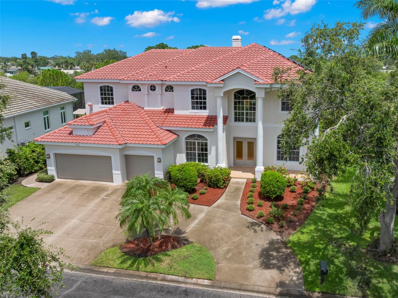 Presenting for the first time ever to the market, 1223 Darlington Oak Circle NE, one of the largest homes in the guard-gated community of Placido Bayou. This grand custom-built residence sits on an oversized lot and offers 4,488 square feet of living space, with six bedrooms, four and a half bathrooms, and a flowing layout designed for elevated everyday living and impressive entertaining. A dramatic two-story entryway with soaring 23-foot ceilings welcomes you into formal living and dining spaces, while a generously sized kitchen opens seamlessly to the main living room, creating a perfect gathering space for family and guests. Large sliding glass doors in the living room offer beautiful views and lead to an expansive screened porch and resort-style pool deck, where a PebbleTec pool, heated spa, and large paver patio await. With ample backyard space and private water access ideal for kayaking and paddleboarding, this home embraces the very best of Florida’s indoor-outdoor lifestyle. All bedrooms, both upstairs and downstairs, are spacious and conveniently connected to a bath. The master suite is enormous and features a separate sitting area, two walk in closets, large en suite bath with walk-in shower, and soaking tub, as well as access to an upstairs balcony. Recent updates include a brand-new tile roof, all-new exterior paint, and a fully paid-off solar system that virtually eliminates electric bills. Other desirable features include an interior laundry room, walk-in pantry, eat-in kitchen, wood burning fireplace, gas generator, and pool bath. The property also features a three-car garage and circular driveway for both function and curb appeal. While the home is waterfront, it has no history of flooding. Move in as-is or reimagine the space to suit your personal vision, this home has limitless potential. The guard gated community of Placido Bayou offers a paradise setting with picturesque lakes for fishing, scenic paths for running, and lush trees providing shade and tranquility. Conveniently located just minutes from downtown St. Petersburg’s vibrant waterfront, you’ll have easy access to an array of dining options, boutique shopping, world-class arts, cultural and sporting events. Desirable options for schools nearby include Canterbury and Shorecrest. Beaches, airports, and golf courses are also just a short drive away, and the Racquet Club of St Petersburg is at the entry of the neighborhood, where you can enjoy both pickleball and tennis! Seize this rare opportunity to call this exceptional property home and experience the Florida lifestyle at its very best.