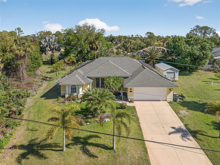 OVERSIZED LOT IN ONE OF THE BEST LOCATIONS IN NORTH PORT! TONS OF POTENTIAL IN THIS 3 BEDROOM, 2 BATH, 2-CAR GARAGE POOL HOME TO MAKE IT YOUR OWN! Whole home solar system provides energy efficiency and monthly savings. French doors lead into an open floor plan with high ceilings, crown molding, plantation shutters, large slider to lanai, formal dining room, spacious kitchen with granite counters and overlooks family room. Primary suite features private bath with dual sinks, garden bath and walk-in shower. Split floor plan provides privacy for all with two nicely sized guest bedrooms and separate full bath plus there is a convenient inside laundry with extra storage. Outside entertaining area features covered lanai and heated screened pool overlooking expansive backyard with outdoor shed for more storage and plenty of room for furry friends to roam. Lush tropical landscaping surrounds the property giving it curb appeal. Newer a/c and hot water heater plus accordion shutters across lanai. Great location close to I-75 for commuting north or south, restaurants, shopping, schools, parks and a short drive to Venice beaches. Don’t miss this opportunity! Schedule your private showing today!