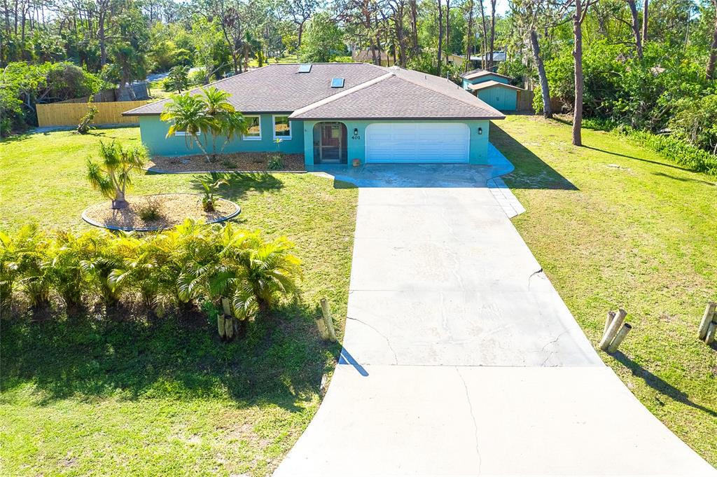 Paradise awaits you in this exceptional 4 bedroom, 2 bathroom home with a desirable split floor plan in the heart of Old Englewood. Enjoy breakfast in your beautifully appointed eat in kitchen with gorgeous wood cabinetry, granite countertops & stainless steel appliances or chose to dine in your spacious dedicated dining room. Relax in your choice of two tranquil living areas or lose yourself in nature while kicking back in your large screened lanai overlooking your more than half acre, irrigated property on a corner lot. Need a dedicated office/den/craft room or fifth bedroom? You've got that too! Skylights fill every corner of this beautiful home with natural light that reflects the ethereal glow of the freshly painted interior walls while brand new wood look ceramic tile gives the home a cohesive feel and flow. A new architectural feature wall has been added to the owners suite for additional character and flare. Keep your vehicles protected in your 2 car garage and your mower and garden equipment in your large outdoor shed with electric. This home, offering all of these wonderful features, is within 1 mile of historic Dearborn street and its' many shops, restaurants, cafes and farmer's market. Englewood and Manasota beaches are 5 miles from your doorstep and quaint Venice, Florida, is a quick 15 minute drive away. This home is hurricane tough and features a newer roof (2017), garage door (2020), impact glass windows, electrical panel (2021) and HVAC (2011). Enjoy living FREE of HOA fees or deed restrictions in this must see property! Schedule your showing today!