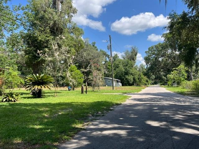 Discover the perfect blend of a country feel on this .25 acre lot (100’ x 100’) while in the city all while being convenience to nearby amenities, including shopping, dining, and outdoor recreation such as a park and Gum Root Park in walking distance. Unique Opportunity in NE Gainesville’s peaceful Copeland community. It also has easy access within only minutes to Gainesville Regional Airport, appealing to those seeking connectivity, convenience, and long-term growth in one of Florida’s most dynamic cities. Enjoy the convenience of being close to the University of Florida, Shands and VA hospitals with Publix shopping center just a few minutes’ drive. Property has been vetted by the county and health departments and is ready and waiting for you. Existing survey and potential floor plan available. Electricity is nearby and property has been cleared providing you with a head start for your construction plans and is waiting for you.