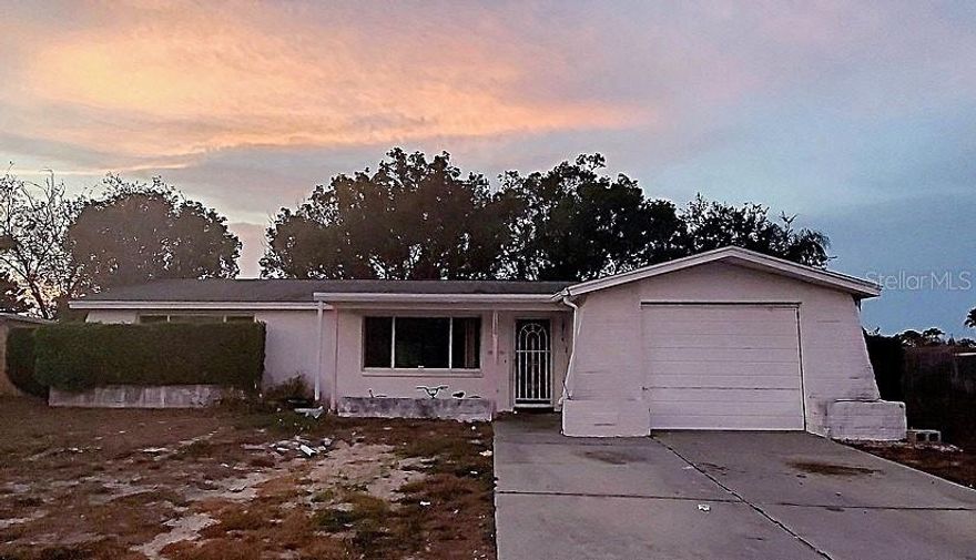 This is a diamond in the rough waiting for your imagination, creativity and sweat equity! The home features an open, flexible floorplan that you can remodel to suit the needs of your family. As you enter through the front door, there is a large open great room with sliding doors to the screened and covered lanai that overlooks the large backyard. Continue down the hallway and beyond a full bathroom and linen closet, are two bedrooms with cedar lined closets. On the other side of the house is a family room with sliding doors that also lead to the lanai. The kitchen area has a pantry closet, and room for a dinette. Beyond the kitchen is a second full bath and doorway access to the attached garage. PLEASE NOTE: For the first 30 day period this property is listed, the seller will only accept offers from Owner-Occupant Buyers, governmental entities, including their instrumentalities, and Nonprofit Organizations.