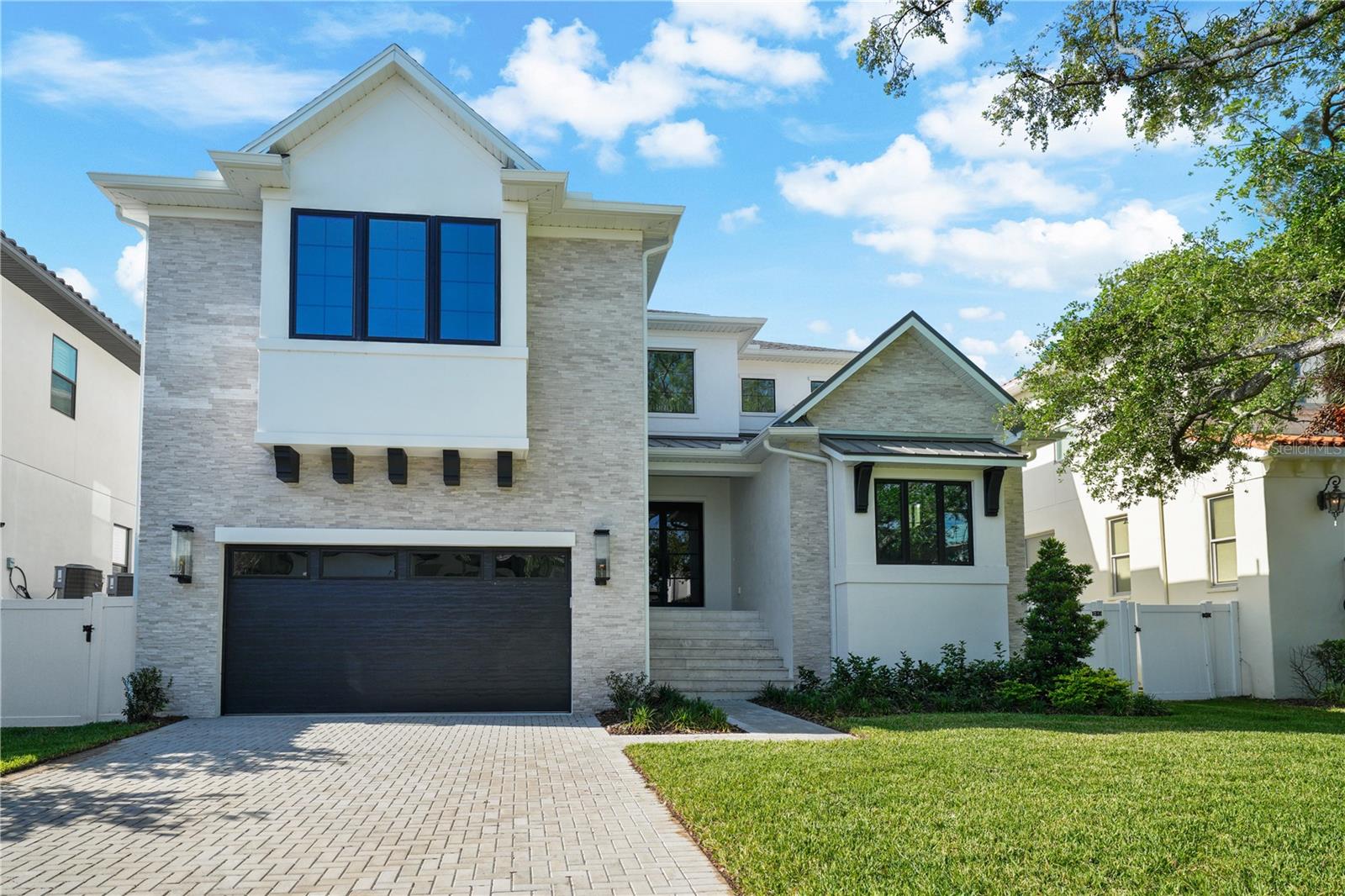 MOVE-IN READY! Your search for new construction is over! 5024 W Dickens is an amazing opportunity to own a BRAND NEW home with a custom feel. Exceptionally built by Gloger Construction, this home not only looks fabulous with its clean lines and warm, natural elements. But reflects the outstanding quality, synonymous with Gloger’s work. Thanks to its reinforced ALL-BLOCK construction, level 4 drywall application, wood tongue and groove exterior ceilings, and impact resistant doors and windows, the finishes on this home rival most custom designs. The quality of construction and attention to detail are apparent from the moment you open the impressive wrought-iron and glass double doors. Note the high ceilings, open floor plan, solid core doors, 10" wide-plank wood flooring and clean site line to the covered lanai and pool. To your right, is the study with exceptional millwork on the cathedral ceiling. To your left, is the entry to the mud room and a butler's pantry with a THERMADOR 24” wine fridge, sink and showcase cabinetry. The mudroom features storage cubbies and a secondary washer and dryer hook-up. But the true gem of this home is the spacious, hidden, working pantry! It features a second dishwasher and fridge, plenty of prep and storage space too. You can access it from the mud room or open the faux cabinet door in the main kitchen for easier access. Close it off and all the clutter is hidden from view! Chefs, prepare to be impressed with the expansive kitchen! Features include custom cabinetry, quartz countertops, ample storage, and an impressive island with a waterfall counter. The appliances are all THERMADOR and include a side by side, paneled fridge and freezer, gas cooktop, two built-in ovens, microwave and paneled dishwasher. The kitchen overlooks the large dining room and spacious family room. Its focal point is textured tile gas fireplace that is sure to impress. Want to entertain outside? Open your wall of sliders to the pavered lanai and outdoor kitchen with oversized grill, beverage fridge and sink. Or enjoy a dip in your saltwater pool and spa! Back inside, guests will appreciate the private bedroom and full bath tucked away from the rest of home. Just when you thought there was nowhere else to entertain, head upstairs! There is a fabulous bonus room with a half bath and space for a pool table, media room or hang out. The secondary bedrooms all have full baths and custom closets. At the end of the hall, through the double doors, is your private sanctuary. The primary suite offers a feature wall and incredible space. There are two enviable walk-in closets with custom shelving. The bathroom offers separate vanities, a soaking tub, a walk-in shower and marble throughout. A large laundry room completes the second floor. The finishes on this home are exceptional and provide the perfect back drop for personalization. Convenient to Tampa International Airport, downtown Tampa and St. Pete. Zoned for A rated schools (Dale Mabry Elementary, Coleman Middle and Plant High), the only thing missing is you! Schedule your showing today!