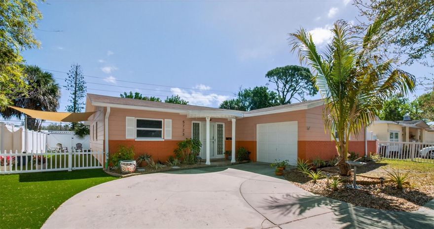 Welcome to this beautifully maintained 3-bedroom, 2-bath block residence in desirable Northeast St. Petersburg, offering a thoughtful blend of modern updates, quality systems, and a low-maintenance lifestyle. The home features soaring 8+ foot ceilings and durable waterproof luxury vinyl plank flooring throughout—completely carpet-free for easy living. Recent improvements include a 15 SEER HVAC system (2023), tankless water heater, an upgraded electrical system with whole-house surge protection, and in-ground gutter drainage system. The inviting interior offers comfortable, updated living spaces and a well-appointed kitchen equipped with newer appliances (approximately 3–4 years old), an owned reverse osmosis water filtration system, and an impressive Euro Cave 182-bottle wine cooler—perfect for collectors and entertainers alike. The fully fenced outdoor spaces are designed for effortless enjoyment, featuring professionally installed synthetic turf in both the backyard and side yard, eliminating the need for mowing while maintaining a lush, year-round appearance. A canvas-covered side yard provides versatile space ideal for a dog run, outdoor lounge area, or boat storage. Additional features include automatic backyard irrigation, a camera security system, private rear alley access, and a smart garage door system. A recently installed impact-rated sliding glass door enhances the dining room and screened-in back porch. With no HOA and no history of flooding, this property offers peace of mind. Ideally situated along the 1st Street bike trail and just minutes from vibrant downtown St. Petersburg, nearby parks, the 62nd Street YMCA, the popular 4th Street dining and shopping corridor, I-275, and more. Seller is a licensed Florida Realtor.