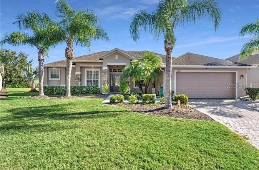 Entertainer’s dream home in a family friendly neighborhood. This cul-de-sac property has exceptional curb appeal, with a paver driveway and walkway leading to double glass entry doors. Inside, you are welcomed by a flexible front room (use as a living room, office, or music room) and a formal dining room, leading through an arched entry into the spacious family room that is open to the breakfast area and kitchen, overlooking the pool. The kitchen is a chef’s dream, featuring quartz countertops, stainless steel appliances, 42-inch upper cabinets, under-cabinet lighting, pot-storage drawers, open shelving, subway-tile backsplash, a pantry closet, a wine/beverage cooler, breakfast bar, and dinette. Oversized sliding glass doors open to a HUGE outdoor entertaining space with a paver deck, covered lanai with large TV, and a summer kitchen that is equipped with a sink, beverage cooler, and grill. The impressive pool is fully screened, solar heated, and includes an automatic cleaner. The low-maintenance backyard is fully fenced and private, with no grass—just pavers and planter beds. A vestibule provides privacy for the primary suite, which features large windows overlooking the pool, two closets with custom built-ins, and an en-suite bath with a garden tub, chandelier, separate shower, linen closet and a double vanity with quartz countertops, and a private water closet. On the opposite side of the home, three generously sized bedrooms—two with walk-in closets—share an updated bathroom with direct access to the pool deck. The utility room connects to an oversized two-car garage. Throughout the home, you’ll find oversized baseboards, 9-foot raised ceilings, and durable, wood-look luxury vinyl plank flooring—great for everyday family living. Nineteen solar panels offset energy costs, making this home an excellent choice for buyers focused on keeping monthly expenses down. The Grand Preserve at Cypress Lakes has resort-style amenities, including a country-club pool with twister slides, splash pad, clubhouse with gym and full kitchen, playground, and sports courts, fully equipped gym, and social areas. Schools are conveniently located nearby: the elementary school is within one half mile, the middle school is one mile away, and the high school is two miles away. The home is also close to the University of Central Florida and major shopping. East Orlando is conveniently situated between the Space Coast (Cape Canaveral and Cocoa Beach) and the theme parks (Disney, Universal, and SeaWorld). This home is a must see.