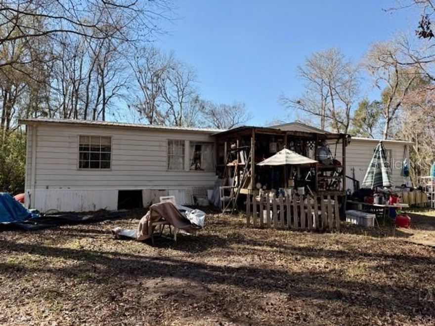 Opportunity Awaits! Situated on 1.22 Acre, 3/2 Double-Wide Mobile Home Offers Spacious Rural Setting, No Neighbors And A Great Split Floorplan Layout, Is In Need of Repairs & Renovation. A Great Opportunity For Investors or Buyers Alike. This Property Has Potential As A Primary Residence, Rental Or Weekend Retreat, Many Possibilities. The Large Lot Provides Flexibility, Room For Expansion Or Future Improvements. Metal Roof, Raised HVAC & Well 2018. Zero Carpet. Scenic View of 16 Mile Creek. Centrally Located In Flagler Estates. NO HOA. 30 Minutes From Iconic St. Augustine and St. Johns Botanical Gardens & Nature Preserve. Call Today!