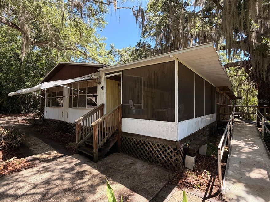 Waterfront Acreage & Handyman Special in Oak Hill

697 Eagle Watch Rd, Oak Hill, FL 32759 4 Bedrooms | 2 Bathrooms | Wrap-Around Porch

An incredible opportunity for investors, contractors, or buyers looking to build sweat equity in a highly desirable waterfront pocket. Situated on an exceptionally large, deep lot on a quiet road, this property offers a rare combination of old-Florida beauty, complete privacy, and a unique natural setting at an unbeatable price point.

The Property & Land: The deep, expansive lot is bordered directly on the east by Indian Creek, providing a peaceful, natural water boundary. Please note: Water access is strictly limited to the creek itself and does not provide deep-water boat navigation. The land is dominated by stunning, historic old-growth live oaks, including one of the largest and most majestic trees in the entire Oak Hill area. In the backyard, a private wooden footbridge arches over the creek, taking you directly onto your own private sliver of land that connects straight into the boundaries of the popular River Breeze Park.

The Potential (Fixer-Upper): The existing structure is a spacious 4-bedroom, 2-bathroom mobile home framed by a massive, sweeping porch on the south and east sides—perfect for enjoying the serene views and shade canopy. The home is a true fixer-upper, is being sold strictly as-is, and is entirely renovation-ready. It will require updates throughout, explicitly including the replacement of drywall, making it the perfect blank canvas to remodel into a premier fishing camp or live in while you plan a future custom build.

The Freedom: Located in unincorporated Volusia County with No HOA, you have total freedom to utilize this land to its fullest potential. There is plenty of room to store your boats, trucks, trailers, and RVs. Plus, while the creek itself isn't navigable for vessels, you are just minutes away from the premier public boat ramp at River Breeze Park, making it incredibly convenient for avid anglers and boaters looking to access the Mosquito Lagoon.

Bring your tools, bring your vision, and claim a rare piece of the coast!