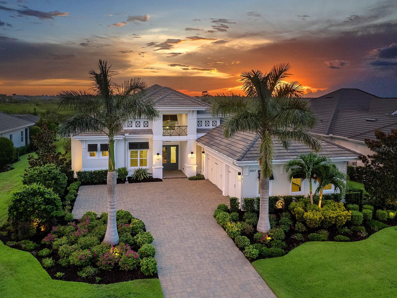 Prestigious living in The Lake Club of Lakewood Ranch in within reach! Nestled among towering palms and verdant landscaping is this completely, custom Madison II home built by Stock Luxury Homes in 2021. The lush Florida conservation wetland provides a beautiful backdrop for the western rear exposure with spectacular sunsets. This entire residence had every detail carefully hand-selected to evoke a luxurious and comforting residence including oak hardwood flooring, cove crown molding and custom ceilings, high-end designer light fixtures, plantation shutters, and top-of-the-line functional selections in every room. Superior details and a sense of security continue with high-end construction, impact doors and windows throughout, additional remote control hurricane screens on the lanai, 22kw whole-house generator, surge protector, and whole-house water filtration system. The central great room is the heart of the home with custom coffered ceiling, custom built-in display shelving and entertainment cabinetry, and a full wall of impact sliding glass doors to the lanai. Enjoy a modern open-concept floor plan that flows effortlessly throughout the living areas and out onto the marble paver lanai. With beautiful and private views of the preserve, the lanai offers a serene space to gather around the gas fireplace and under wood ceilings, take in the views from panoramic screen enclosure, or dine by the outdoor kitchen. The custom saltwater pool offers a sunken 360-edge spa, sunshelf, Nebula lights built into the screen enclosure to create a starlight effect above, and a built-in fire bar feature plus water bowls – you won’t find another lanai like this at any other home. The luxurious lifestyle continues indoors with the executive kitchen that is expertly outfitted with high-end appliances including Wolf gas cooktop, Miele dishwasher, Sub-Zero refrigerator, and dual Wolf wall ovens. The custom cabinetry offers complimentary two-tone colors, thick quartz counters with full-height backsplash, pots and pans drawers, additional integrated pantry tower, and a walk-in pantry with shelving. The adjacent dining room has custom ceilings, disappearing corner impact sliders, and a breathtaking designer chandelier. Work from home in the study equipped with dual built-in desks with glass tops, file drawers, and display shelving. The primary suite sparkles with designer wallpaper, custom ceilings, impact French doors to the lanai, and impressive dual walk-in closets with custom closet systems. The spa-like bathroom gives you a five-star experience with dual vanities, make-up space, linen closet storage tower, modern freestanding soaking tub, and walk-in shower with rain shower head. Guests will find similar comfort in two guest suites with their own private en-suite bathrooms. The spacious rear bonus room is ideal for gathering with a custom dry bar with quartz counters, mirrored backsplash, display cabinetry, and two Sub-Zero wine refrigerators. There is also a dedicated full pool bathroom with walk-in shower and exterior lanai access, plus a guest powder bathroom. A functional laundry room, mudroom-style garage entry, spacious 3-car garage and oversized driveway complete this impressive home. You’ll also enjoy a lower property tax bill than other homes because the debt portion of the CDD Lakewood Ranch Stewardship has been PAID OFF. The Lake Club is an exclusive premier, gated community with a Grande Clubhouse, restaurant, pool, tennis, pickleball and more.