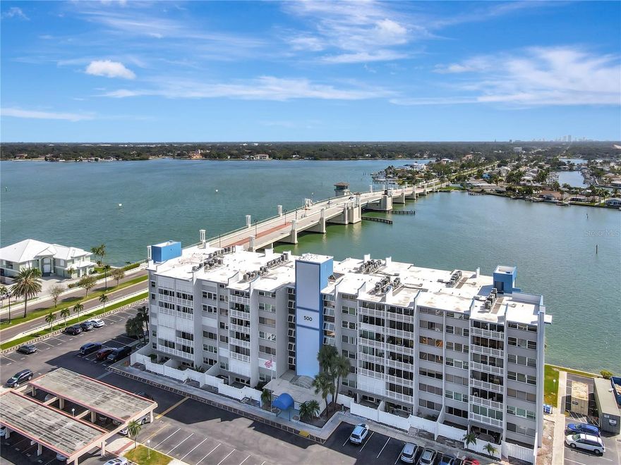 Turnkey 2BR/2BA condo at the base of the Treasure Island Causeway Bridge—an easy stroll to the sugar-sand Gulf beaches. This open floor plan showcases amazing natural light from the moment you walk in. Major upgrades include hurricane-impact windows & doors (big-ticket item done), 2020 HVAC, and two full-size water heaters so you never run out of hot water. The kitchen features stainless steel appliances, including a 2024 dishwasher and refrigerator; there are generous closets throughout plus a convenient indoor laundry room. Sold fully furnished for immediate enjoyment. Pet-friendly building. Parking is easy with two spaces (one assigned and one additional reserved/unassigned) and ample guest parking. All assessments for this unit are PAID IN FULL. Enjoy low-maintenance coastal living with dining, shopping, and the beach just minutes away. No hurricane damage to this unit