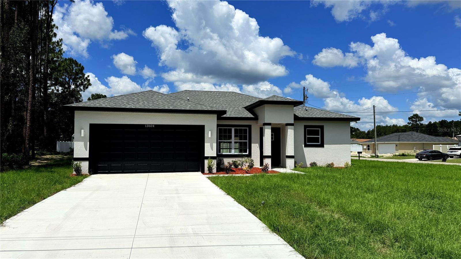 Under Construction. 0.25 CORNER LOT. Brand-new house in Ocala! This stunning home combines modern style and convenience with 4 bedrooms and 2.5 bathrooms. The master bathroom is a true retreat, featuring a stunning STANDALONE TUB and a sleek SHOWER DOOR for added style and functionality. The spacious open floor plan is perfect for hosting large family gatherings, and the fully equipped kitchen includes stainless-steel appliances—refrigerator, range, disposal, dishwasher, and microwave, along with a stylish QUARTZ WATERFALL ISLAND that adds a touch of elegance. Additional features include a SMART KEY system for enhanced security and the peace of mind that comes with a 2-10 HOME BUYERS WARRANTY. Don’t miss out—schedule a showing today!