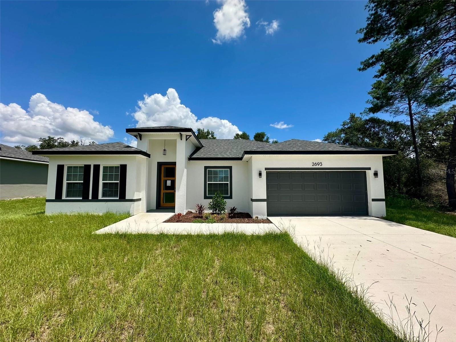 Brand New 2025 Home. This beautifully built, move-in ready home is located in Marion Oaks, Ocala. It features 4 spacious bedrooms, 2 modern bathrooms, and elegant quartz countertops in both the kitchen and bathrooms. The open concept layout is enhanced by high ceilings, vinyl flooring throughout, window blinds, ceiling fans, and a 2-car garage. The kitchen includes high-end stainless-steel appliances. No HOA! Perfect for primary residence or rental investment.