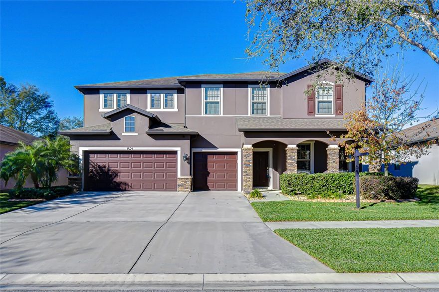 Imagine living and entertaining in this beautifully designed Pulte Mariner home offering over 4,000 sq ft, 5 bedrooms, and 3.5 bathrooms in the desirable Highlands Reserve of Valrico—with no CDD fees. Ideally located just minutes from the Greater Hillsborough County Fairgrounds and the beloved Berry Barn, this Craftsman-style residence features stone accents, graceful archways, lush landscaping, a three-car garage, and an extended driveway for ample parking. Inside, soaring ceilings and upgraded ceramic tile welcome you into a spacious foyer. A versatile main-level flex room is perfect for a home office, formal living space, or playroom. Thoughtfully designed with functionality in mind, the builder utilized every inch of space to maximize storage and livability throughout the home. The open living and dining areas are ideal for entertaining and flow seamlessly into the chef’s kitchen, featuring granite countertops, an oversized island with seating, stainless steel appliances, 42” cabinetry, and two walk-in pantries—a rare and highly sought-after feature. An informal dining area connects to the family room with multiple sliding glass doors, including a fully retractable triple-panel slider that opens to the screened paver patio for effortless indoor-outdoor living. The main level also includes a half bath, mudroom, and a dedicated laundry/utility room with additional storage. Upstairs, a spacious loft and bonus family/game room provide even more flexibility for everyday living or entertaining. The split-bedroom layout offers privacy, with three guest bedrooms featuring walk-in closets, along with multiple climate-controlled storage closets throughout—perfect for seasonal items and organization. The primary suite is a true retreat with tray ceilings, a generous double-sided walk-in closet, and a spa-like bath featuring dual vanities, a glass-enclosed shower, a private water closet, and abundant storage. A fifth bedroom with a full bath, ideal for guests or multi-generational living. The oversized, fully fenced backyard offers endless potential to build your dream outdoor oasis, complete with a covered paver patio, sprinkler system, and in-wall pest control. Additional updates include a 30-amp transfer switch for a portable generator, a recently added water softener system, new exterior paint, a water heater, and landscape lighting. Conveniently located near shopping, dining, hospitals, major highways, and local favorites, this home truly offers space, storage, and location—don’t miss it!