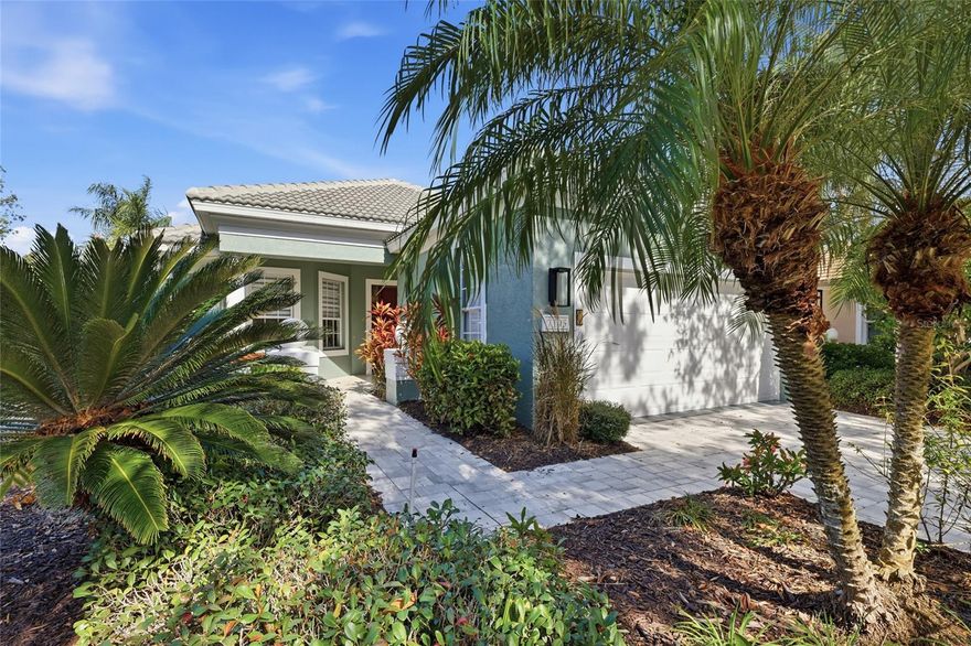 THIS IS A BEAUTIFULLY UPDATED HOME! POINT LAKEFRONT HOMESITE WITH A FABULOUS LAKE VIEW! Upon entering the impressive gates of University Park, with mature trees lining The Park Blvd., it’s clear this is a special community. Tucked away on the cul-de-sac in the Notting Hill neighborhood, this floor plan is designed to showcase sweeping lake views from the kitchen, great room, and primary bedroom. Professional landscaping and custom paver driveway enhance this homes front elevation! The 2-bedroom, 2-bath home includes a separate dining room, den with French doors, tile throughout.  Upgraded high end light fixtures! The updated chef's kitchen features quartz countertops, new stainless steel appliances including a 6 burner natural gas range, double oven, double drawer dishwasher, high end cafe refrigerator, refreshed cabinetry, and a cozy breakfast nook. The spacious primary suite offers dual walk-in closets and a well-appointed bath with a walk in shower and very relaxing air soaking tub.  An extended, screened lanai with picture windows screening overlooks the pond, creating an ideal space to relax or entertain. The lanai has beautiful travertine flooring. Two car garage with an epoxy coated floor. THE ROOF IS JUST 4 YEARS OLD! Notting Hill is a grounds maintenance free neighborhood. The community pool is conveniently located just a few minutes walk from this special home. Please note that there is a rear entrance to University Park Country Club close to the Notting Hill neighborhood giving its residents excellent driving access to UTC Mall, Whole Foods, and fabulous restaurants!