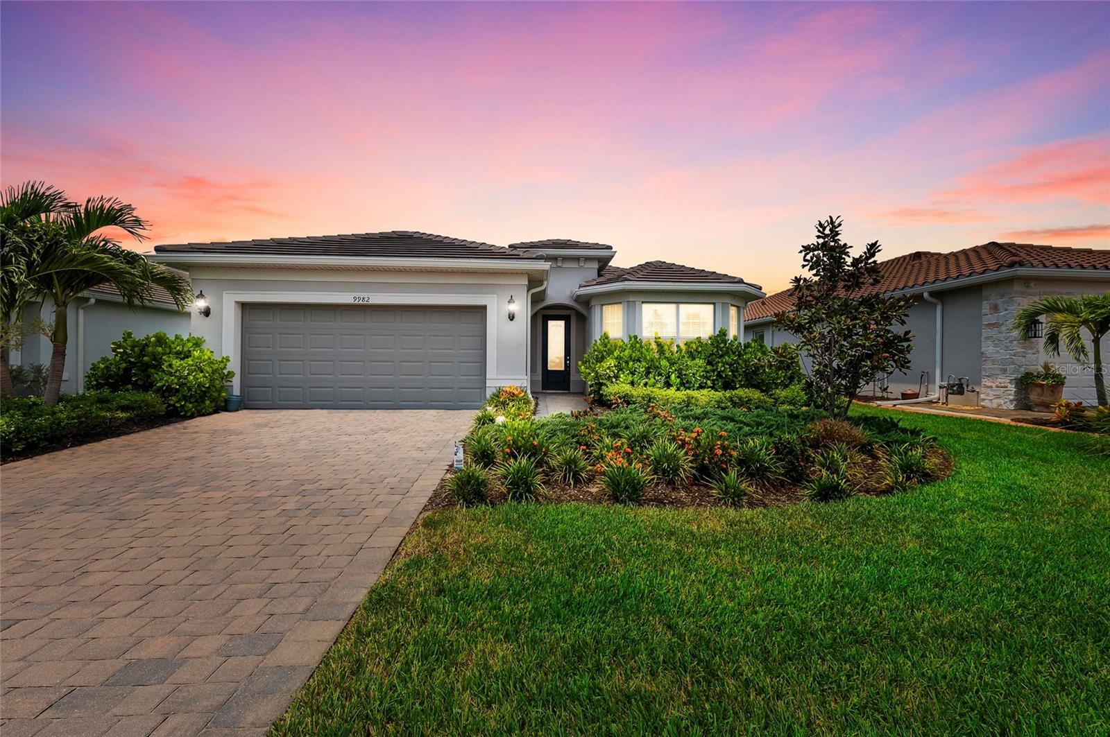 One or more photo(s) has been virtually staged. Welcome to one of the most sought-after homes in the gated, resort-style community of Beachwalk by Manasota Key. This meticulously maintained 2023-built Mystique model offers the perfect blend of luxury, privacy, and functionality—outshining builder specs with high-end upgrades throughout.
Situated on a premium private preserve lot, this home boasts lush, upgraded landscaping and a beautifully designed heated saltwater pool—your own backyard oasis.
Inside, you’ll find elevated 8’ doors and higher baseboards, porcelain tile laid on the diagonal throughout the main living areas, and upgraded carpeting in the bedrooms. The decorative glass front door, paver driveway, and tray ceilings in both the living room and primary suite add to the home’s custom feel. Extensive LED can lighting and designer fixtures elevate the overall ambiance. The den features elegant glass French doors with shades and a built-in closet, offering the flexibility to serve as a fourth bedroom if desired.
The kitchen is a showstopper with upgraded soft-close cabinets featuring dovetail construction, quartz countertops, a large center island with a composite sink, and premium stainless steel appliances including a gas cooktop. A large walk-in pantry and double sliding glass doors open to the lanai, seamlessly blending indoor and outdoor living.
The primary suite overlooks the private pool and includes a custom walk-in closet, tray ceiling, and a luxurious ensuite with quartz countertops, dual sinks, a frameless glass shower door, and designer tile with a custom inlay. The secondary bedroom includes its own private ensuite, perfect for guests, while the third bedroom is positioned at the front of the home with charming bay windows and close proximity to a third full bathroom. All guest bathrooms have been upgraded with premium cabinetry, quartz counters, and tile work. The oversized laundry room includes an upgraded washer and dryer, custom built-ins, and is pre-plumbed for a sink.
One standout feature is the oversized garage with a 4-foot extension and sleek epoxy floors, offering ample room for storage, a workspace, or larger vehicles—ideal for the hobbyist or anyone in need of extra space.
The outdoor living area is equally impressive, featuring an extra-large covered lanai that provides plenty of room to relax or entertain while enjoying the tranquil view of the heated saltwater pool and preserve beyond.
Beachwalk by Manasota Key offers an unrivaled resort lifestyle. Residents enjoy access to the Capri Clubhouse, which features a state-of-the-art fitness center, two movement studios, card rooms, a social lounge, and a café. The tropical saltwater pool includes lap lanes and a heated spa, and multiple onsite dining options include a restaurant, bar and grill, and a poolside tiki bar. Sports enthusiasts will appreciate ten pickleball courts, five tennis courts, and six bocce ball courts. Outdoor amenities also include a lakeside boardwalk with a pier and gazebo, fire pits, a dog park, and a community garden. Walking trails, both paved and unpaved, extend throughout the community and into the nearby Lemon Bay Park & Environmental Center.
This home combines location, luxury, and lifestyle in one exceptional package. Skip the wait for new construction and step into a thoughtfully upgraded, like-new residence in one of Southwest Florida’s most desirable gated communities.