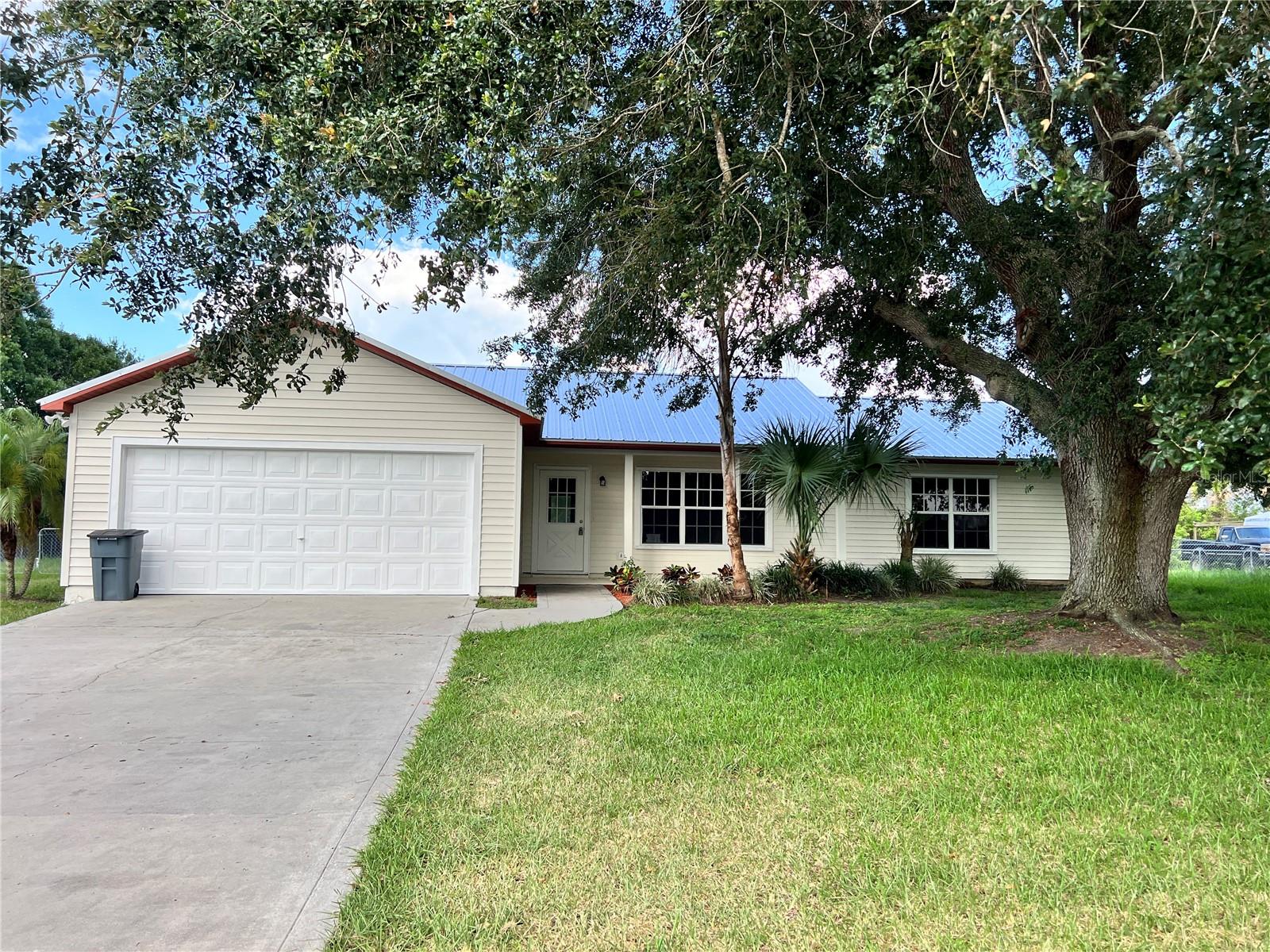 3 bedroom, 2 bath wood frame home with 2-car attached garage in highly sought-after family friendly SW subdivision of Lazy 7 Estates. Split floor plan with large screened back patio plus an unscreened BBQ area just outside patio. Home sits on a half-acre lot with a fully fenced backyard double-gated on one side for easy drive-in access. Adorable front entry and porch shaded by the large Grandfather Oak in the front yard. New metal Luviano roof in 2025. New paint, interior and exterior, in 2025. Septic, well and full home inspection on hand. Backs up to open field for evening views from the porch. This one is a must-see.