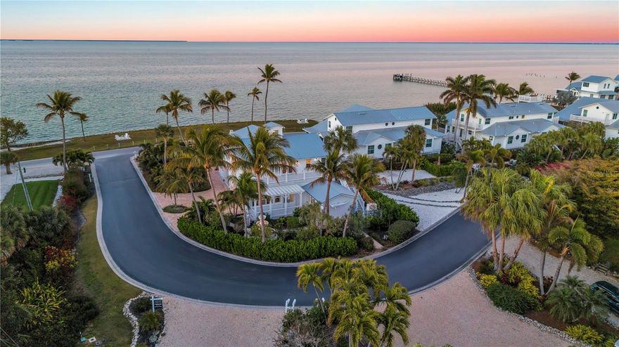 Formerly known as the iconic Bokeelia Tarpon Inn featuring 4 bedrooms, 5 bathrooms and may be purchased TURN-KEY. This historic estate blends early 1900s character with over $1 MILLION in high-end upgrades. PLUS, This home qualifies for 100% Bonus Depreciation on FF&E values!! Located on the northern tip of Pine Island, where the views simply do not get better. Enjoy water views from nearly every window in the home. Primary has Panoramic Views of Charlotte Harbor!  With 2 BOAT SLIPS and lift access, you’ll have quick and easy entry into Charlotte Harbor, Matlacha Pass, and the Gulf. Stepping into the home, the grand front entrance offers a massive covered sitting space, a perfect place to soak in the sunshine, coastal breezes, and peaceful waterfront scenery. Vintage charm greets you at every turn, beautifully preserved and enhanced with thoughtful modern updates. Natural light fills the home, creating a bright and airy feel throughout. The gourmet kitchen is a true showpiece, featuring a Big Chill refrigerator and gas range with unlacquered brass hardware, a designer industrial Zephyr ventilation hood, and a brass pot filler for added convenience. Brick flooring is laid in a classic herringbone pattern, while dramatic soapstone countertops elevate the space. The open-concept living area showcases porcelain tile flooring and a stunning touchstone built-in electric fireplace. Just off the main living area, the laundry room adds convenience. Enjoy garden views from the only downstairs guest bedroom. Upstairs, solid wood flooring and custom hardwood stair treads maintain the home’s historic integrity. You will find the expansive primary suite features vaulted ceilings and a cozy revolution, built-in electric fireplace. The spa-inspired primary bath offers water jet-cut marble mosaic tile on the vanity wall, shower inset, and shower floor, a freestanding soaking tub with a Kingston Brass floor-mounted tub filler and hand shower, and custom solid wood cabinetry beneath quartz countertops. Additional Features include: 2 A/C units, spray foam insulation, a walkable attic with additional storage, a high-efficiency tankless water heater, a permanently installed Generac standby generator, a HOOT aerobic septic system, ELECTRIC HURRICANE protection, and Kevlar protection for the upstairs lanai. The exterior is equally impressive with James Hardie shake siding, all-new Azek decking, railings, and stairs, and a custom-built pergola with electric. The oversized lot is beautifully landscaped with mature fruit trees along with a coral fountain surrounded by a rose garden. You are just minutes from world-class boating and fishing destinations including Boca Grande Pass and Cayo Costa. You’re also close to the Bokeelia Fishing Pier, charming island dining, Pine Island Center, and everything that makes Pine Island such a peaceful and desirable coastal community. With breathtaking water views, historic significance, luxury finishes, and unmatched zoning flexibility, this is truly a one-of-a-kind investment and lifestyle opportunity.