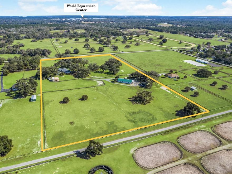 One or more photo(s) has been virtually staged. Spectacular 20+/- acre farm located in the heart of NW Ocala and only a couple of minutes to the World Equestrian Center. Fall in love with the beautiful tree dotted, lush acreage. The property boasts a completely updated brick home, center aisle block barn, multiple storage buildings and lush paddocks. The home is a ranch style 4 bedroom, 3 bath brick home-completely remodeled and updated with a beautiful contemporary design and finishes. The home has an inviting large living room with fireplace and overlooks the patio area and pool. The master suite opens to a large sun room where you can enjoy the view of the beautiful farm. Guest rooms are spacious and the home even has a game room! Just a few short steps away, you will find the large block center aisle barn with 12 stalls, tack room and bathroom. This farm would be great for any discipline, with a huge turf field just behind the barn for riding, large round pen, and loading ramp. A second shedrow barn has 6 stalls, and you will also find a large storage building, perfect for tractor and equipment storage. Don’t miss this unique opportunity to own this special farm in a stellar location!