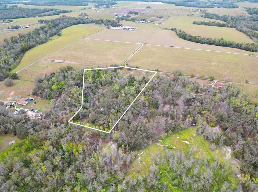 Tucked away in the rolling hills of Dade City, this private 10-acre property offers an outstanding opportunity for a custom estate, equestrian setup, or peaceful country escape. The land is partially cleared and features a desirable mix of open pasture and mature oak trees, creating a naturally shaded, scenic setting with plenty of usable space. A tranquil spring-fed creek runs through the property, adding both character and a calming natural element to the landscape. A built-in deck is also included, providing a relaxing spot to take in the peaceful views of the acreage and surrounding nature. Enjoy a sense of seclusion while still being conveniently located just 5 minutes from I-75, approximately 40 minutes to Tampa, and about 20 minutes from the shopping, dining, and entertainment options. Whether you’re planning to build a custom home, establish a horse property, or create a private retreat, this versatile parcel offers privacy, natural beauty, and strong potential in one of Dade City’s most desirable areas.