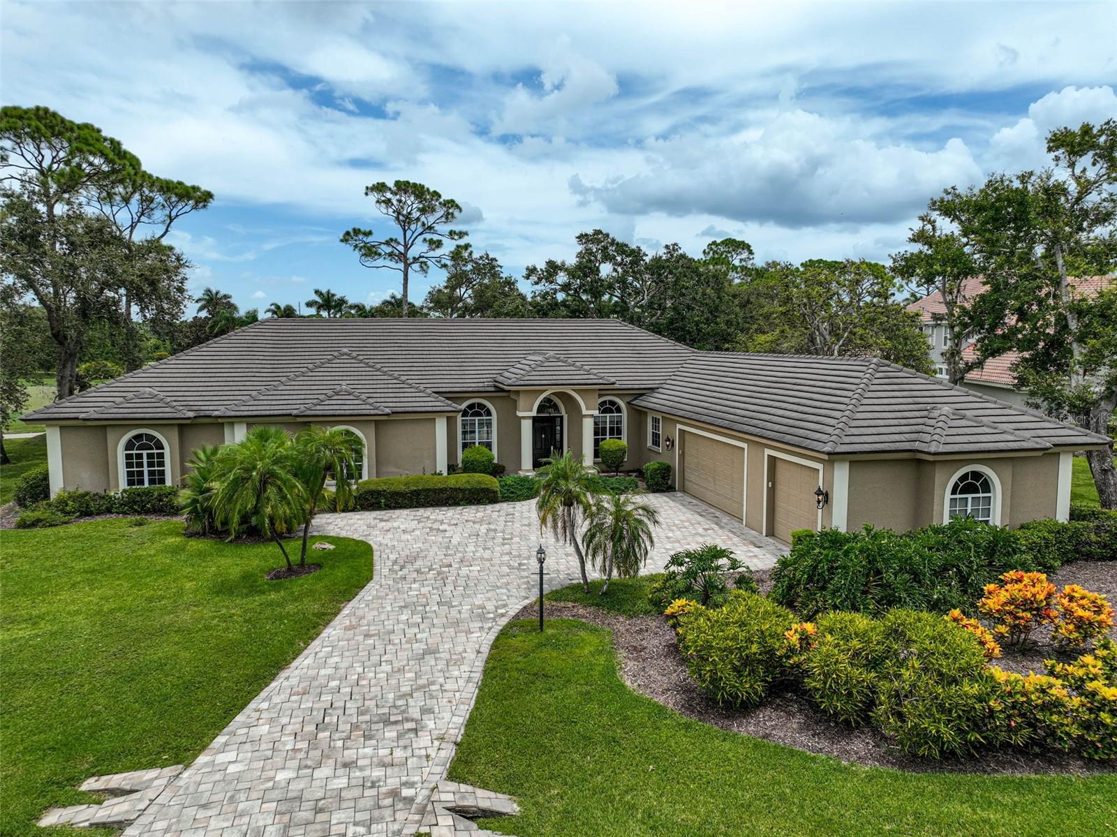 **CHARMING and PRIVATE, GOLF COURSE ESTATE** is located behind the Secure Gates of the highly sought after Oaks Country Club community and offers a Lovely, Golf Course View of the 17th Fairway of the interior, Heron Golf Course. This Spacious, Light and Bright, Open Floorplan of OVER 4500sf entails 3-BEDS, 3 FULL and 1 HALF BATHS, Study/Den, Bonus Room / Entertaining area with Fireplace and Wetbar, 3-CAR GARAGE, etc. Premium features abound including Crown moldings, Marble and wood floors, Coffered ceiling, Custom built-ins, a well-equipped kitchen with Granite countertops, Stainless Steel Appliances including KitchenAid and Fisher & Paykel, and much more! An Expansive Primary Bedroom Suite features a Bonus Room, Walk-In Closet, dual vanities, soaking tub and custom-tiled shower. Enjoy OUTDOOR LIVING at its FINEST in an Expansive, Screened Lanai with PEBBLETEC Pool & Spa and Outdoor Kitchen in a serene setting. NEW HURRICANE IMPACT SLIDING DOORS and WINDOWS; ROOF (2015). THE OAKS is a distinguished, 24hr Guarded, Country Club Community which boasts many accolades including: Platinum Club of America, Emerald Club of the World, Elite Distinguished Club of the World and One of America’s Healthiest Clubs - where amenities include Three Restaurants, Ballroom, Two 18-hole championship GOLF courses, award-winning RACQUETS program with 12 Har-Tru Hydro-Grid TENNIS courts, 4 PICKLEBALL Courts, wonderful CROQUET facility, state-of-the-art FITNESS center and junior Olympic, heated community SWIMMING POOL, Bocce, Basketball Court, Playground and more! The Oaks is just minutes from nationally ranked Pine View School, the Legacy Bike Trail, area Beaches and all that Gulf Coast living has to offer. Membership is required and there is NO WAITLIST for GOLF or SOCIAL Membership. **Please Enjoy Viewing the 3D VIRTUAL TOUR**