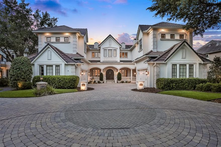 We proudly present one of the finest lakefront homes in the highly desirable gated community, The Highlands of Lake Conway. With impeccable architecture and one of Orlando’s most enviable settings, this remarkable lakefront estate is spectacular and livable in equal measures. Majestic lines, luxurious appointments, and incomparable views are perfectly situated on over 80 feet of Lake Conway shoreline frontage. Gated and exceedingly private, the home's walls of windows and generous patios, terraces and lanais provide seamless flow for lavish entertaining and sparkling vistas of lakefront shoreline. As soon as you enter the residence, you are met with a sweeping staircase and bright open formal spaces with soaring gallery walls and exquisite detailing. Gourmet kitchen boasts custom white cabinetry, state-of-the-art appliances, a large island, and two pantry spaces. The kitchen opens to a family room, which showcases a gas fireplace, volume ceilings, and incredible views. Just outside is a gorgeous lakefront lanai complete with a covered dining area, retractable remote screens, outdoor kitchen. A heated chlorine or salt water pool with spa, and a large open air outdoor living space with private ivy adorned steps lead you to your sandy beach and lakefront. Stunning vestibule takes you to the first floor primary suite showcasing a gas fireplace, French doors that lead to the lanai, gracious walk-in closet, and stunning master bathroom with walkthrough shower with multiple shower-heads, and garden tub. Two separate stairwells lead to the second floor living area.  Topping this magnificent residence is an enormous second floor family room with game space and full bar complete with custom cabinetry. Upstairs terrace is ideal for entertaining, lounging, or stargazing. 1545 Conway Isle Circle exudes luxury, discerning taste, and offers unmatched premium lakefront living with upgrades including: gym area, multiple office spaces, and touch-less remote boat cover on private dock all while being minutes from Downtown Orlando, Dr. Phillip’s Performing Arts Center, theme parks, and the airport. Call today for a private showing.