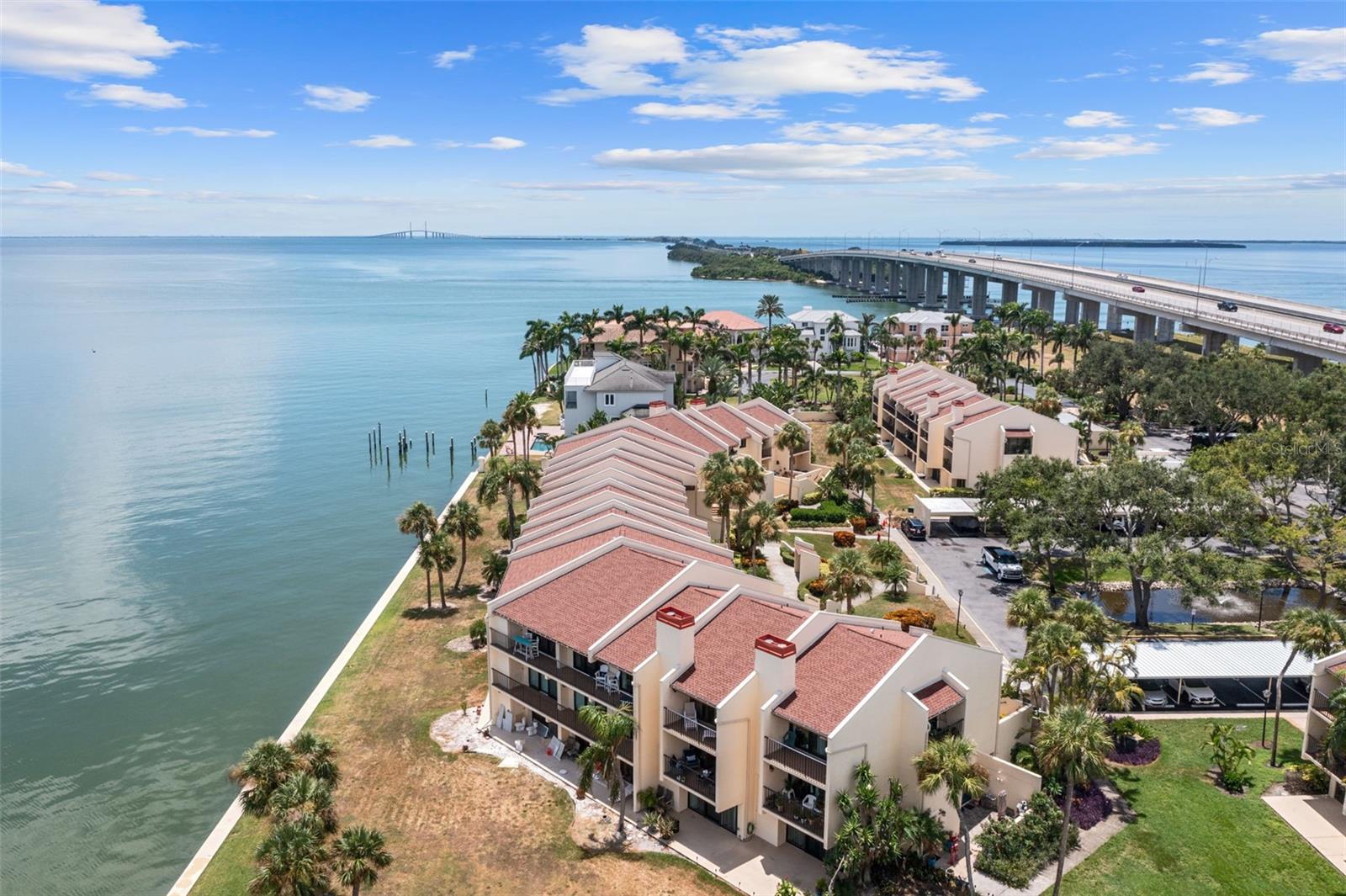 Breathtaking Tampa Bay Waterfront Living! Enjoy spectacular panoramic views of the water and the iconic Sunshine Skyway Bridge from this beautifully updated second floor condo in highly sought-after Seapointe Terrace. Impact-rated floor-to-ceiling windows and sliding glass doors in the living room and both bedrooms open to a 40-foot balcony, perfect for morning coffee, relaxing with a book, or watching unforgettable sunrises. Fully renovated in 2018, this home boasts a spacious kitchen with granite countertops, stainless steel appliances, a breakfast bar, and abundant natural light from the west-facing balcony. The open-concept living and dining area creates a seamless flow for entertaining. Wood-grain tile flooring enhances the main living spaces, while both en-suite bedrooms feature luxury vinyl plank flooring. The split floor plan provides privacy, and the guest suite includes a full-size washer and dryer. Additional conveniences include storage on the balcony for beach gear, plus community storage areas for larger items. Resort-style amenities include a heated pool, kayak launch, tennis, pickleball courts, and beautifully maintained grounds. The community has passed the Milestone Study and features fully funded structural reserves for peace of mind. Perfectly located, this condo is just minutes from I-275, offering quick access to downtown St. Petersburg and Tampa International Airport. You’re less than 15 minutes from Fort De Soto Park and the pristine Gulf beaches, and within walking distance to marinas, Maximo Park, and the Sky Beach Resort with live entertainment several nights a week. Wake up to breathtaking sunrises and end your day with the sparkling lights of the Sunshine Skyway Bridge, welcome to your dream waterfront retreat. Schedule your private showing today!