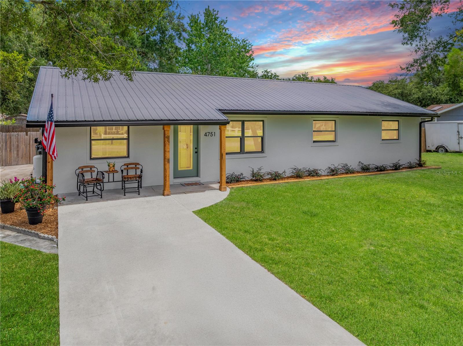 One or more photo(s) has been virtually staged. DON’T WALK! RUN TO SEE THIS GORGEOUS PROPERTY with the WOW-FACTOR! 1900 SQUARE FEET OF LIKE NEW CONSTRUCTION, but with a BIGGER LOT and NO HOA RULES! USDA 100% FINANCING ELIGIBLE! LOW TAXES! DOUBLE HUNG, HURRICANE IMPACT WINDOWS and a METAL ROOF protect this BEAUTIFULLY RENOVATED 4 bedroom on nearly a 1/3 acre, private, fenced, corner lot, spotted with mature shade trees. Ideally located in the County, between Hickory Tree and Canoe Creek Rd., minutes to shopping, restaurants, banks, pharmacies, parks, schools, FL Turnpike and St. Cloud’s renowned downtown and Lakefront Park. Orlando and Lake Nona are about 25 minutes away. For the avid fisherman, boat ramps for Lake Gentry and the spectacular Alligator Chain of Lakes are only about 5 minutes away! The exterior boasts a fresh paint job, new stucco and doors, 2 driveways, a double gate, a carport, shed and TONS of parking along the corner. The big back yard is perfect for your RV, boat, trucks, trailers, work equipment, trampoline, ATVs, workshop, playground, pets, pool and all your toys. Love entertaining? BBQ, play corn hole, volleyball and horseshoes, or lounge at your fire pit. Want to be self-sustaining? Plant a huge garden and build a greenhouse; room for solar panels, too! This dramatic reno draws you in the second you open the door! Right away you feel the subtle, modern farmhouse vibe and appreciate the bright, redesigned, open floorplan highlighted by great sight lines, new, modern fans, fixtures, recessed lighting, accent wall, luxury vinyl plank flooring, and new paint and texture. The stylishly designed kitchen features all wood, soft close cabinetry with crown, all drawer bases, quartz countertops, brand new stainless appliances including a microwave drawer, custom tile backsplash and a stunning island. Large pantry and more cabinets in laundry room. Flex room in back is perfect for a family room, office, gym or mancave. Both bathrooms completely renovated, including custom tile showers, new vanities, toilets, mirrors and lights. Even the interior doors have a custom, farmhouse design. It’s getting hard to find a home like this with no HOA. Why wait for new construction when you can move in now and enjoy luxurious finishes and upgrades most builders don’t offer! This well-appointed retreat is just awaiting your family to make it an extraordinary place to live! DON’T FORGET TO LOOK FOR THE HIDDEN DOOR! Click virtual tour link for walkthrough video. Renovation list and other notable improvements and features attached to listing.