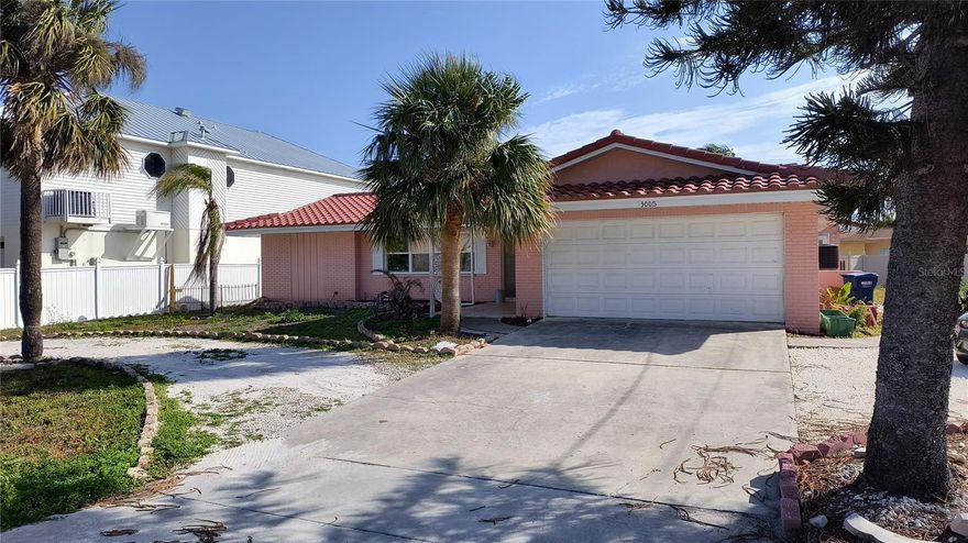 Enjoy this 3-bedroom,2 bath home in Belleair Beach just across the street from the beach. This home offers a split bedroom plan,open floor plan with living room, dining room, family room.  All tile floors, new kitchen with island, lots of storage. inside laundry room, two car garage. Yard is shared with studio apt .