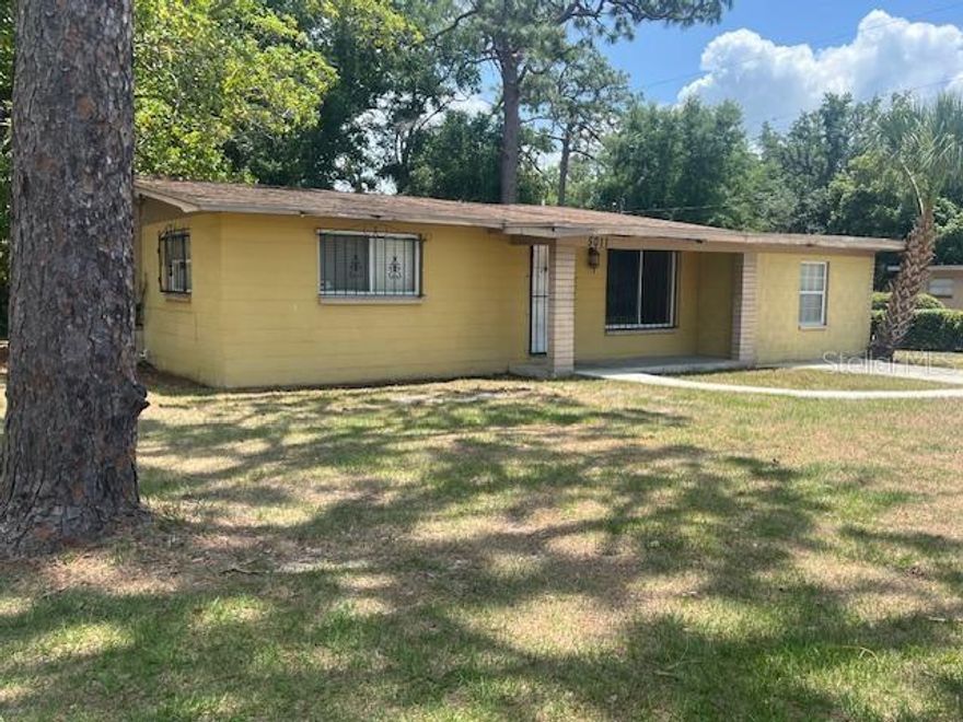 Looking for a solid block home on a huge corner lot that could possibly be split. You are at the right place. This spacious 3 bedrooms 2 bath home includes living room, dining area and family room. The large owner suite and bath with combo shower and tub. The ample 2nd and 3rd bedrooms are on the other side of the house offering a little more privacy for the owners. Wood laminate flooring and tile throughout so… NO Carpet! The Kitchen needs appliances and would make a great DIY project. New Roof and New AC to be install prior to closing. The lot is a third of an acre with a block single car detached garage. This home needs some TLC but has so much potential, it’s a must see!