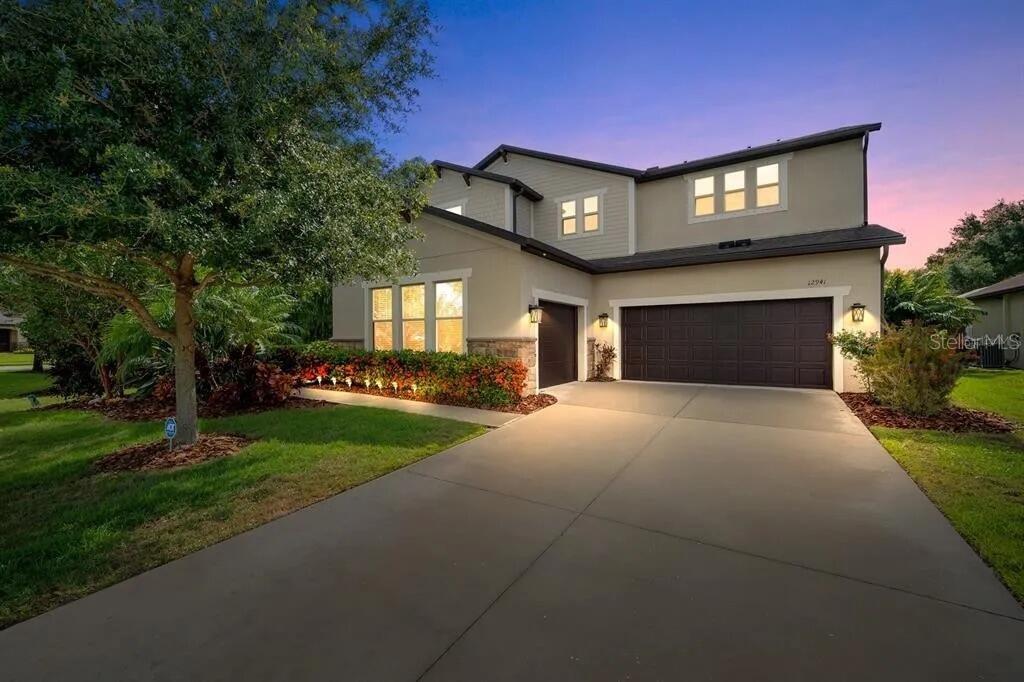 The moment you walk in the front door of 12941 Bliss Loop in the beautiful gated community of Serenity Creek, you’ll know you’re home. With 5 bedrooms, 4 full bathrooms, and nearly 3,700 square feet of thoughtfully designed space, there’s room for everyone and everything.
You’ll be greeted by warm wood plank tile flooring, crown molding, and natural light pouring in from every direction. The main living space flows right into the gorgeous open kitchen with granite counters, induction cooktop, double convection oven, walk-in pantry, and plenty of built-in cabinetry. There’s even a whole home water filtration system already in place.
The main level also includes a flexible 5th bedroom or office with a full bathroom nearby, plus a large mudroom with built-ins that leads to the garage.
Upstairs, you’ll find a spacious loft that works great as a game room or second living area. The primary suite feels like a retreat with a walk-in closet, dual vanities, granite countertops, and even private access to the laundry room. Super convenient. Three more bedrooms upstairs each have walk-in closets. Two share a Jack and Jill bathroom, and the other has its own full bath.
The oversized pool is gorgeous with a sun shelf, waterfall, and new heater. It’s all wrapped in a vaulted screened lanai and surrounded by lush tropical landscaping that makes the whole place feel like your own private resort.
The lot is the best in the neighborhood, with peaceful views of the open community green space and pond behind it. It honestly feels like you’ve got a second backyard without the extra mowing. The view of the space from the upper loft and bedrooms is stunning.
You’ll also find a brand new roof (2024), a 3-car garage, and an outdoor kitchen for evenings spent poolside at sunset.
The home has a security system, hurricane shutters, and is located in a gated neighborhood with no CDD fees.
This neighborhood is in a top-rated school district, close to everything in Lakewood Ranch, including golf, restaurants, shopping, and I-75 for quick trips. And if you love the beach, the stunning Gulf coast is just 30 minutes away.
This home checks every box. Come see it for yourself and picture your own endless summer lifestyle.