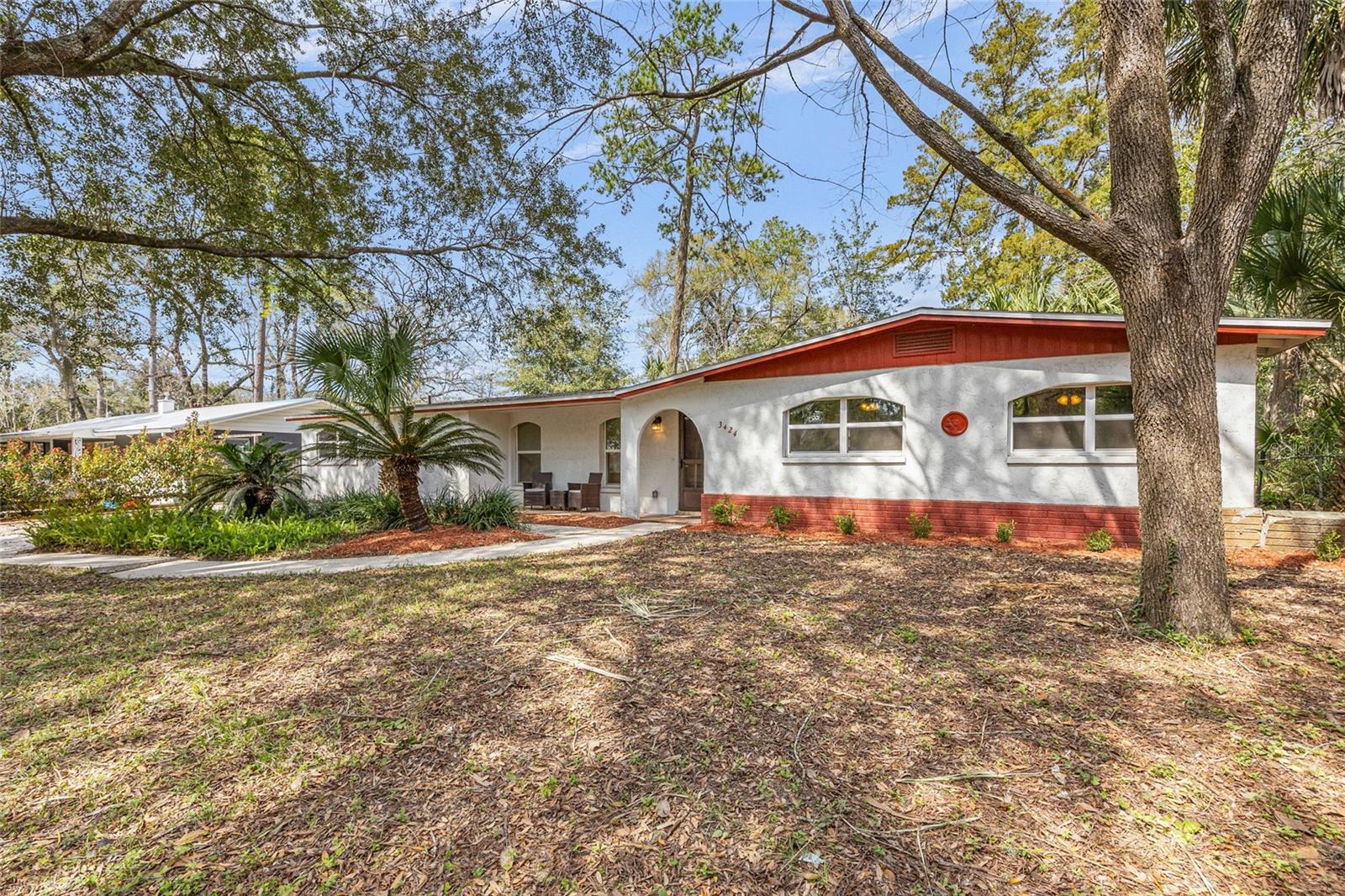Short Sale. This is a short sale.
Do you have a vision for your dream home close to the heart of Gainesville? This charming 4-bedroom, 2-bathroom home in Westside Estates offers 1,588 square feet of thoughtfully designed living space on a spacious quarter-acre lot, ready for you to move in and make it your own.
From the moment you arrive, you’ll notice the welcoming curb appeal, featuring a low-maintenance front yard adorned with palm trees and a striking front archway that gives the porch its standout charm. Inside, the open living and dining area is filled with natural light and finished with tile flooring throughout.
Through another graceful archway, you’ll find the updated kitchen, complete with granite countertops, stainless steel appliances, white shaker cabinets, and a statement backsplash. Just off the kitchen is a cozy flex space, perfect for a breakfast nook, reading corner, or home office, and a laundry closet tucked conveniently nearby.
The split floor plan offers privacy, with the primary suite located to the left of the home. It features an en-suite bath with a walk-in shower. The remaining three bedrooms, located on the opposite side, share an updated hall bathroom with a modern vanity and tiled shower/tub combo. Each bedroom offers generous built-in closets and attractive luxury vinyl plank flooring.
Step outside into the oversized screened-in porch, ideal for morning coffee or winding down in the evening, overlooking your paver patio and fully fenced backyard. There’s plenty of space to entertain, garden, or just enjoy Florida’s sunshine.
Major systems including the roof, HVAC, water heater, and windows were all updated in 2017, and high-speed AT&T fiber optic internet is available for seamless work-from-home days. With no HOA fees, you’ll enjoy flexibility and affordability, all just minutes from UF, UF Health Shands, shopping, dining, and Albert Massey Park just across the street!
Please note that about $7000 of mold remediation is needed in the guest bathroom.