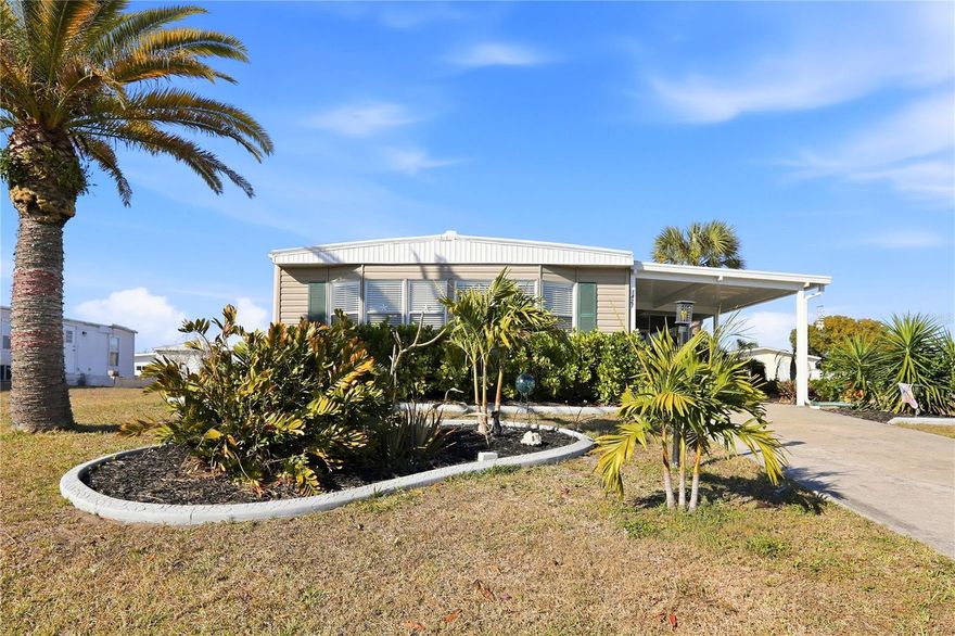 A Double Wide Manufactured Mobile Home in the 55+ Holiday Mobile Home Estates that offers so much, yet likely the LOWEST HOA & FEE IN THE STATE OF FLORIDA & YOU OWN YOUR OWN LAND! Sounds good? Let's list the really great things now. This one is brightly updated and refreshed to meet anyone's tastes. The Florida Style is apparent in each room so you always know you are in Paradise. A Turn-Key home (Yes...just bring your clothes & toothbrush) and you are set. Pulling into your driveway, you are greeted by a very nice carport and lush landscaping accenting a massive living room window for all of the Florida sunshine. A sizeable living room area for your family & guests along with dining space, a kitchen with island cooktop & additional seating; then top it off with plenty of cabinets for all of your needs. Moving into the 2 ample bedrooms and 2 full baths PLUS a bonus reading/library space and laundry area gives you 1344 square feet of remarkable living space. The Primary Bedroom offers a fully updated Ensuite Bath with stand up shower, gorgeous double vanity-dual sinks and dual industrial style mirrors. Your guest bedroom is Florida styled for your guests to enjoy along with the 2nd updated full bath. An interior laundry room makes doing the chore much easier. With plenty of windows to enjoy not only the sunshine coming in but your view to the outside as well. Speaking of outside: your brand new fully screened lanai is the place to unwind and really enjoy the evening breezes and wave to your neighbors buzzing by on their golf carts. Also included is an outdoor shed for additional storage. Remember, you own the land so there is no required monthly maintenance fee. An annual fee of $35.00 is it. A Membership to the Edgewater Club is optional for $315.00 annual. The Edgewater Club offers a wide range of activities including a heated pool, shuffleboard, tennis & pickleball courts, horseshoes, a boat ramp and a small dock. The community is quite active and the clubhouse also hosts many social events throughout the year including poolside music, monthly dinners, bi-monthly Sunday breakfasts and other social events. You are only 6 minutes to one of 5 beaches, fine dining, fresh seafood, parks, a farmers market, boat, kayak, paddleboard, bike, sea doo rentals and more. Englewood is not a city. Englewood has kept much of the Old Florida Charm by staying under the radar and is one of Florida's best kept secrets. Englewood has not developed like many of its sister cities. The Town of Englewood has open spaces and mangrove lined creeks which is why most of the those areas are protected. Did you notice there are no tall buildings in Englewood and no condo's more than 4 stories high on it's barrier island. Updates: Roof (2025) by Roofing Del Sol under Florida Engineering: Crawl Space repair - (2023) with Insulation w/new Vapor Barrier: New plywood and siding (2022) by Georgia Pacific double 5 Dutch lap Vision Pro: Standard Wind-load Design 40 pad pressure rating 12 ft: New AC (2025) with 10 year warranty by Dependable Air : Maytag washer and dryer with new electrical by Bentley and Sons November (2022): 8X12 Shed added 2023: 21'X12' new lanai added 2024: Hot Tub from Recreational Warehouse 735 L Spa Pkg 2024: Navy Sectional 2023: Club Golf Cart