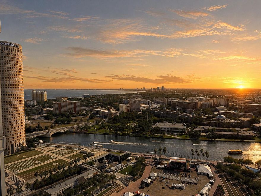 Experience elevated downtown living in this stunning fully furnished 2-bedroom, 2-bathroom corner residence on the 24th floor of SkyPoint. Floor-to-ceiling 10-foot glass windows frame breathtaking panoramic views of the Hillsborough River and Tampa Bay, delivering unforgettable sunset views night after night.The thoughtfully designed kitchen features granite countertops, stainless steel appliances, 42-inch wood cabinetry, and a breakfast bar that opens seamlessly into the expansive living area, perfect for both everyday living and entertaining.The spacious primary suite offers a true retreat with floor-to-ceiling blackout curtains, a custom walk-in closet by California Closets, and a luxurious en-suite bath complete with dual vanities, granite countertops, a soaking tub, and a separate glass-enclosed shower.This residence is rich in upgrades and functionality, including added wall insulation for enhanced privacy, a custom built-in Murphy bed, built-in desk, two additional coat closets, and a full laundry closet with side-by-side washer and dryer.Rent includes water, sewer, trash, high-speed internet, and laundry, offering exceptional value and convenience.Residents enjoy access to SkyPoint’s premier amenities, including 24-hour concierge service, secured assigned parking, a state-of-the-art fitness center, rooftop heated pool and spa, clubroom with full kitchen, theater room, billiards, outdoor grilling stations, and valet dry cleaning services.Perfectly positioned in the heart of downtown Tampa, with dining just downstairs and parks, the Riverwalk, and vibrant city life just steps away.No pets permitted per HOA restrictions for tenants.