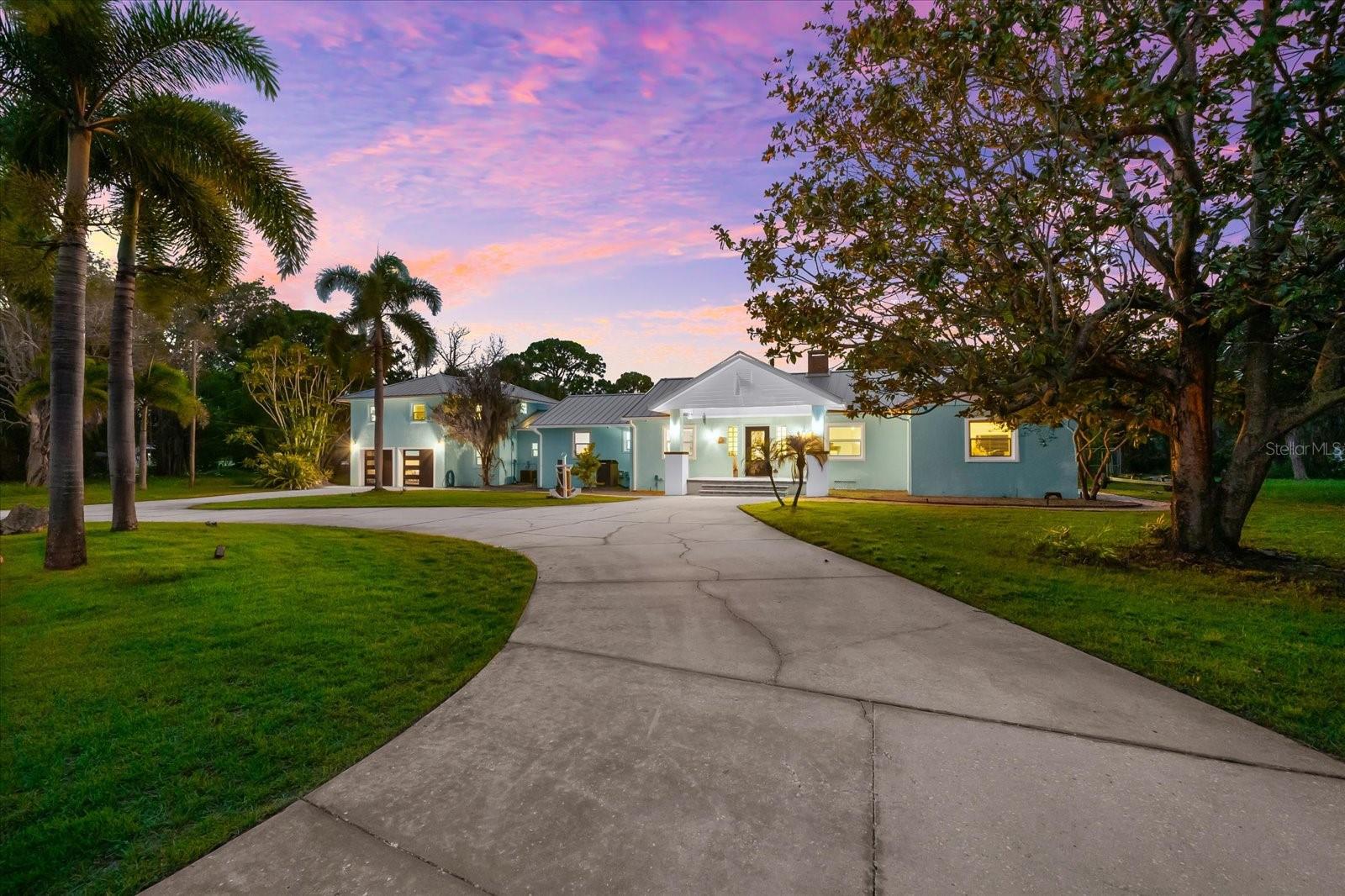 We are pleased to present this waterfront estate in one of America’s best small towns. This home sprawls over .62 of an acre and offers wonderful privacy. It also offers direct access to the Gulf of America and a situated on Sunset Lagoon through Kreamer Bayou. You will first notice the expensive front yard complete with circular driveway for easy access and entertaining. The covered front porch speaks of old Florida as it stages you towards the entrance. Step through the front door into the open foyer and dining room combination. You greeted by a large table and the original brick fireplace built in 1947. The openness of the space allows your guests to instantly enjoy the resort style backyard and pool and then out to the waterfront. Just a few steps ahead, you will experience the openness which flows the family room, kitchen, and eat-in space all as one. Plus the wall full of windows draws that Coastal vibe into your every day living. The seller spared no expense when renovating the kitchen with all custom cabinetry topped with a beautiful level six granite. Additional enhancements include subzero refrigerator, Dual zone Wine Fridge, commercial grade gas range complete with grill/griddle, double oven and under counter microwave. This open space is also just adjacent to an open den or office. It would also be a terrific secondary family/play room should you have the need. The floor plan of the four bedrooms is a magnificent split to where there’s exceptional privacy for everyone. Downstairs overlooking the backyard is a secondary master suite great for a multigenerational situation or older family members that don’t wanna navigate the stairs. However, up those stairs is the true exceptional master suite. Elevated and overlooking the backyard, pool and water is truly special. Complete with wet bar, outdoor balcony for watching the sunsets and huge floor space with plenty of room to use as sitting area, office space, exercise, equipment, and more. This is the only upstairs bedroom and is the ultimate and privacy. Additional improvements to the home include 7 inch baseboards, new tile floor, spray foam insulation, epoxy, garage floor, new garage doors, whole house, generator, and so much more. We look forward to offering you a private tour today.