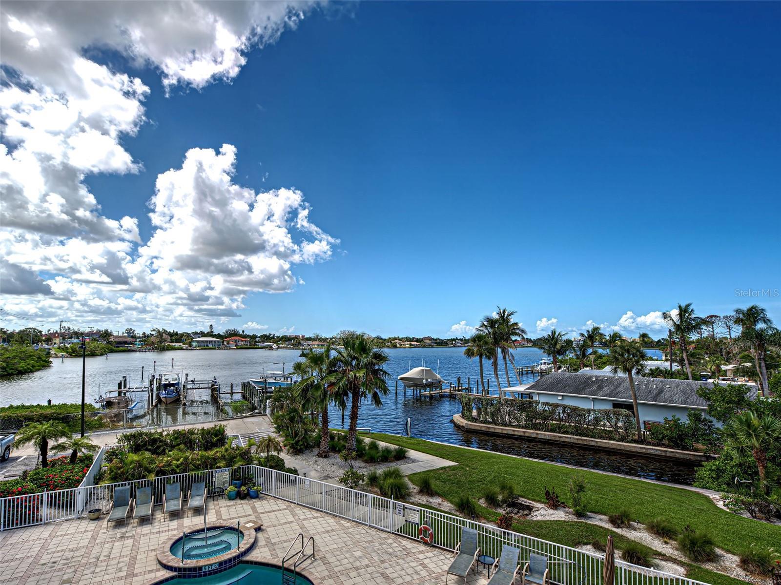 WATERFRONT DREAM HOME with private boat dock, minutes to the Gulf of Mexico and the Intracoastal Waterway. Located in a prime waterfront location offering wonderful views over Dona Bay and amazing sunsets. This bayfront condominium offers everything for the boating, fishing and water enthusiast. Boasting over 2,400 square feet, this three bedroom, three and half bath condo feels like a home. Step off the elevator and into a wide welcoming foyer that ushers you into a spacious, elegant living area with a strong focus on the full width water views. The large kitchen features hardwood cabinetry, stone counter tops, an island, a pantry, a breakfast bar, and a separate dinette area for breakfast or casual dining. The thoughtful owner has extended the kitchen cabinetry for additional storage. Two spacious bedrooms, each with their own en suite bathroom, make for a comfortable and private experience for your overnight guests. The primary bedroom faces Dona Bay and has full width sliding hurricane glass doors opening onto a spacious with amazing views. Bring your boat…there is a private dock with a 7,100# lift in place, electricity, water and fish station. The Gulf and Intracoastal Waterway are less than 10 minutes away with no bridges so bring your sailboat. Resort-style amenities complete the picture including a bay front heated pool and jacuzzi, a fitness center and clubhouse. Two garage spaces are provided in the ground floor secure garage with extra spaces outside for your guests. Enjoy the phenomenal sunsets over Dona Bay every evening…this truly is waterfront living at it’s finest!