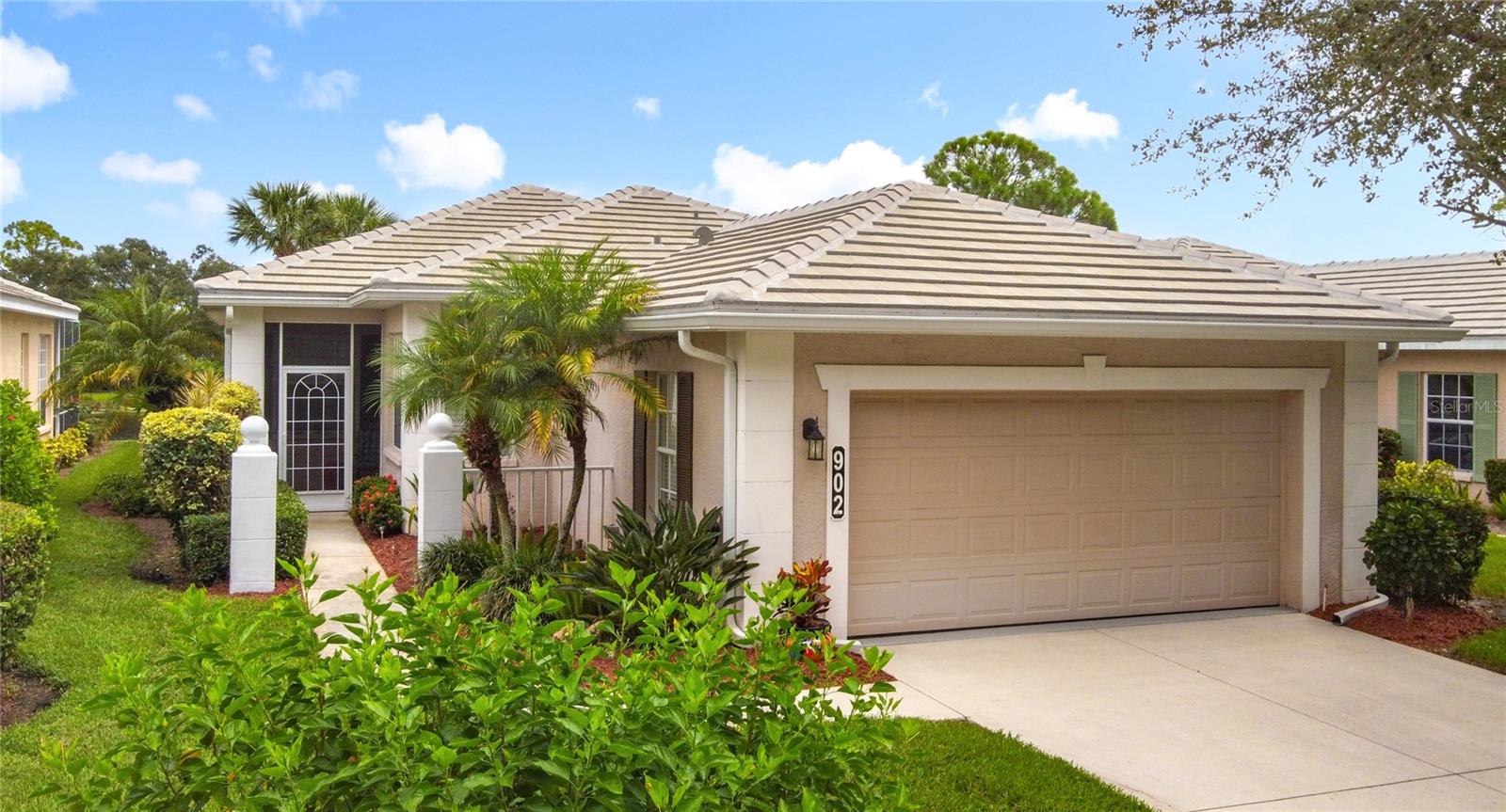 SWEEPING WATER VIEWS IN PLANTATION GOLF & COUNTRY CLUB! Experience the 'best of both worlds' - carefree condo living with the feel of a single-family home. This elegant 3 bedroom, 2.5 bathroom, 2 car garage detached villa offers nearly 2,000 sq. ft. of light-filled living space with lakefront views, high ceilings, crown molding, plantation shutters AND MORE! Recent improvements include a NEW ROOF (2023), NEW AC (2023), NEW HOT WATER TANK (2025), and wood-look flooring in bedrooms for easy care (no carpet here!). This home is a storage lover’s dream, featuring a spacious hall closet, LARGE WALK-IN CLOSETS in both the primary and guest bedroom, linen closets in both bathrooms, cabinetry in laundry room, and a generous kitchen pantry to keep everything organized. The gourmet kitchen features granite countertops, Noir stainless steel appliances, sliding cabinet shelves, breakfast bar, under-cabinet lights, and bay-window dining nook. When it's time to unwind, the spacious primary suite features a bay window with water views, soaking tub, frameless glass shower, and dual vanity. Enjoy seamless indoor-outdoor living with a screened front porch and EXTENDED REAR LANAI overlooking the serene lake, where you'll enjoy bird watching and nightly sunsets. The versatile bonus / sunroom creates the ideal spot for a craft area, music room, reading nook...the possibilities are endless. Laundry room has been thoughtfully upgraded with stylish cabinets, granite countertop and utility sink, leading to an epoxy-finished 2-car garage with convenience and style. Located in the desirable Plantation Golf & Country Club community of The Villas of St. Andrews II, this neighborhood has tree-lined streets and a majestic live oak adorned with orchids in your front yard. Residents enjoy maintenance-free living with reasonable and stable HOA fees — all assessments have been paid, ensuring peace of mind for the future. HOA fee includes roof reserves, exterior painting (to be completed this Fall), structural insurance, lawn care, irrigation, basic cable, and community pool just a short stroll away. OPTIONAL MEMBERSHIP at Plantation Golf & Country Club is available, giving residents access to two championship 18-hole golf courses, 13 Har-Tru tennis courts, 6 pickleball courts, state-of-the-art fitness center, a Jr. Olympic pool, exceptional dining and social events. This makes Villas II perfect for those seeking an active lifestyle, social events, and luxury amenities. Just minutes to Venice beaches, Wellen Park, shopping, dining, and the Atlanta Braves stadium. Don’t miss this rare opportunity for carefree lakefront living! (Disclaimer: some interior photos have been virtually staged)