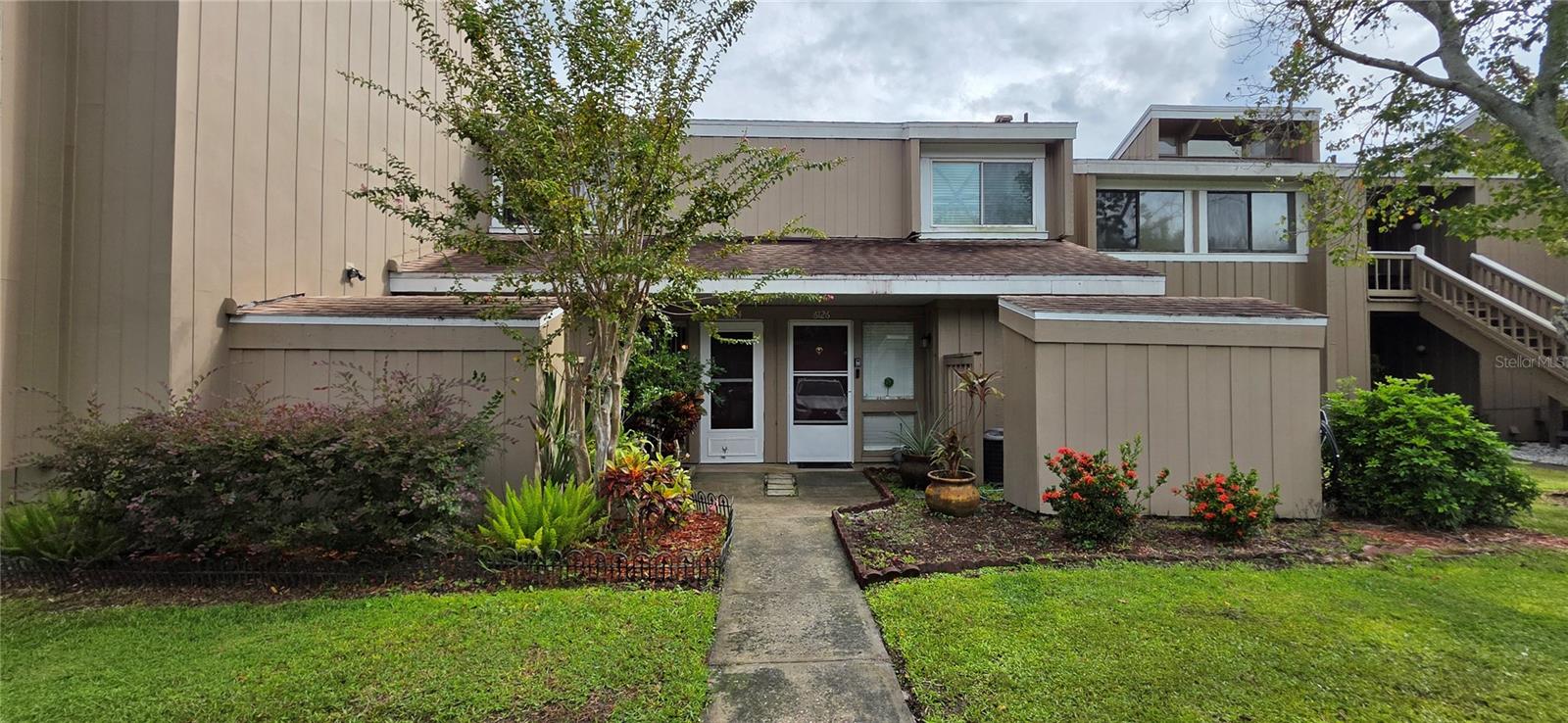 Lakefront Townhouse style Condominium Community with a Prime Location across from Universal Studios, minutes to all Theme parks, attractions, shopping, dining and major roadways. Cozy and charming, nicely landscaped 2-level home with beautiful water views from the Master Bedroom and Living Room area. Offering 2 bedrooms and 1 full bathroom upstairs, and 1 half bathroom with laundry downstairs for your convenience, as well as an outdoor patio space just off the living room, with serene views to relax, barbecue or entertain, as well as a spacious outdoor storage area at the front of the home. Nestled in an excellent location on a winding lake, this home provides a peaceful retreat while keeping you close to everything. Enjoy being within walking distance to Universal Studios. The community features a sparkling pool, tennis court, and picturesque walkways around the lake—perfect for relaxing strolls. This move-in ready townhome offers a bright and welcoming layout ideal for comfortable living. Whether you’ve been dreaming of owning your first home or a vacation home, this home checks all the boxes. HOA Includes: Water, Sewer, Trash, Insurance, Pest Control, Lake Maintenance, Landscape, Pool, and Tennis Courts. New roof (also covered by the association) in 2020. NEW water heater. AC is older but in good working order. Seller will provide a home warranty up to a max of $500 and ***$5,000 closing costs*** with full price offer. 1 Assigned parking space directly in front of unit along with plentiful additional parking spaces.