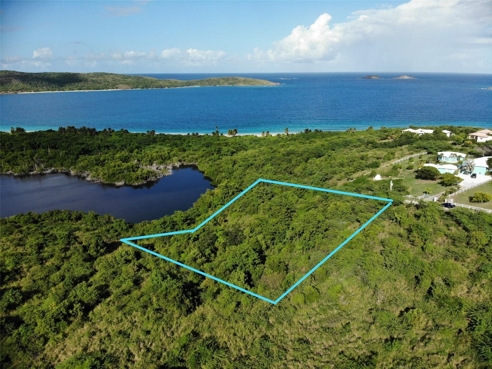 Located in the coveted Alturas de Zoni, this very private corner plot offers breathtaking ocean views of the neighboring islands of Cayo Norte, Culebrita and the US Virgin Islands. Exposure to the north shore and the trade winds ensures a nice climate year round. The top part of the land has a gentle slope ideal for building your island dream home taking advantage of the views. The lower part of the terrain slopes more dramatically to reveal the greenery of the tropical forest next to it and Culebra’s second largest lagoon. The Lagoon is its own ecosystem with a plethora of tropical and marine birds, heaven for nature lovers and bird watchers. And whitesand Zoni Beach is only a short walk away or a 3 minute drive.